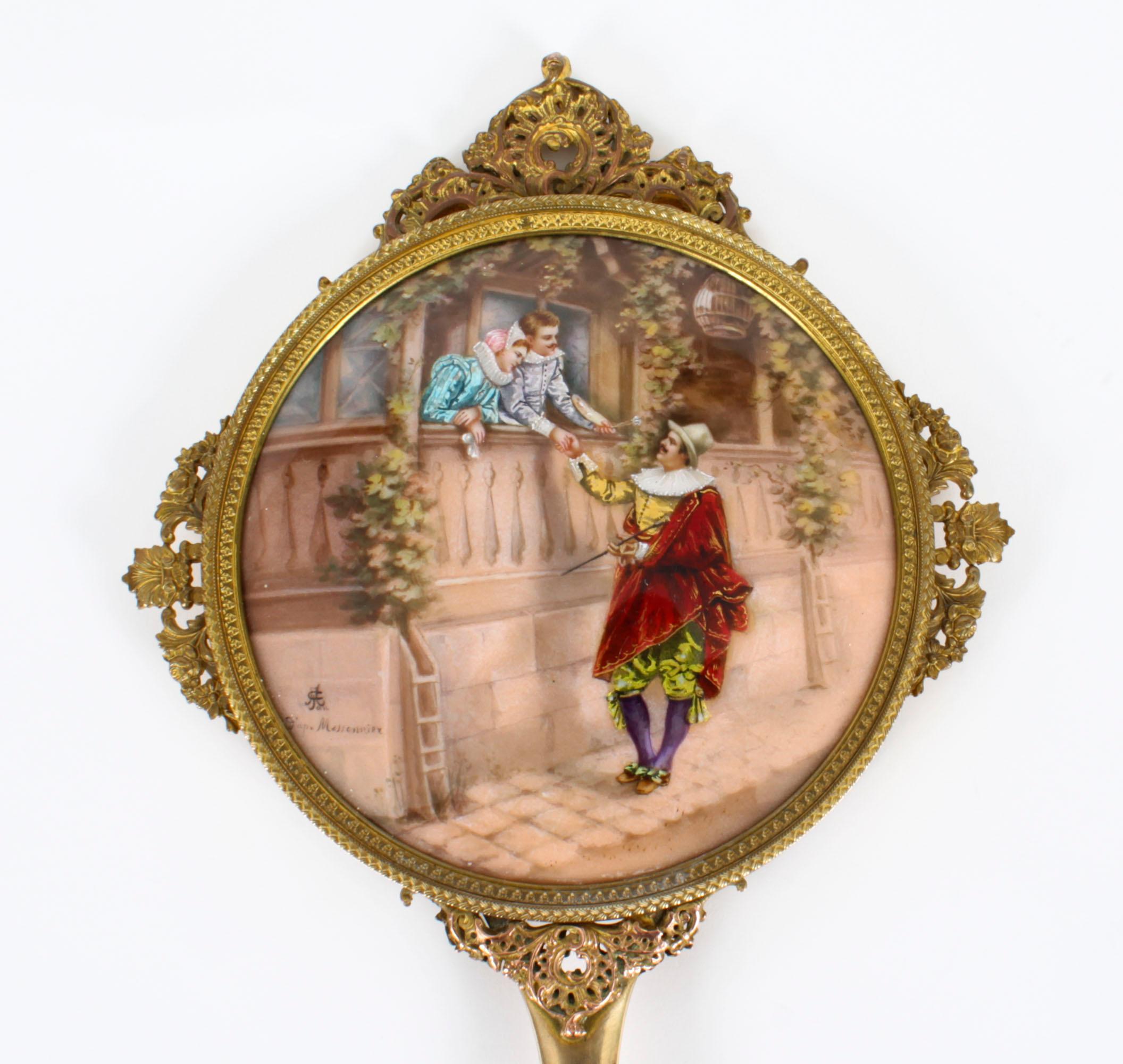 This is a wonderful antique French Limoges panelled ormolu hand-mirror, signed by the artist Joseph Meissonnier, Circa 1890.
 
The circular frame has a pierced scrolling foliated border enclosing a convex centre enameled classical scene with