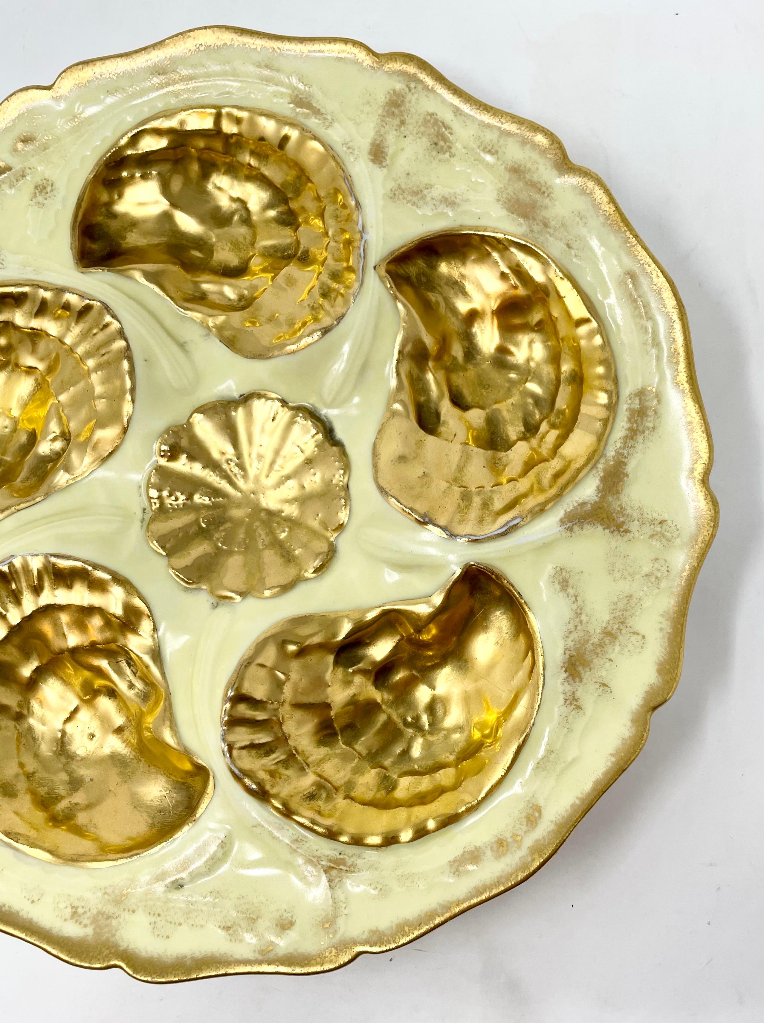 Antique French hand-decorated porcelain oyster plate in rare yellow color with fine gold detail, signed 