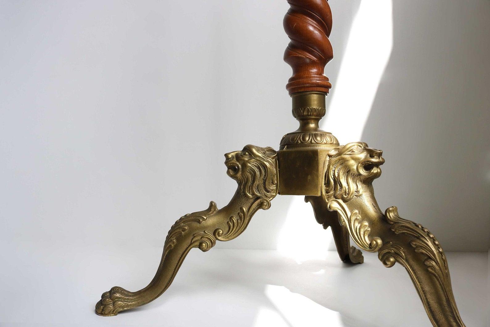 This high quality, ornate hall tree dates to the 1940's.
A stunning and very well made ornate brass and wood coat stand.
With turnable crown and casted brass hooks, and three lightly curved legs are embellished with lions heads and end in the