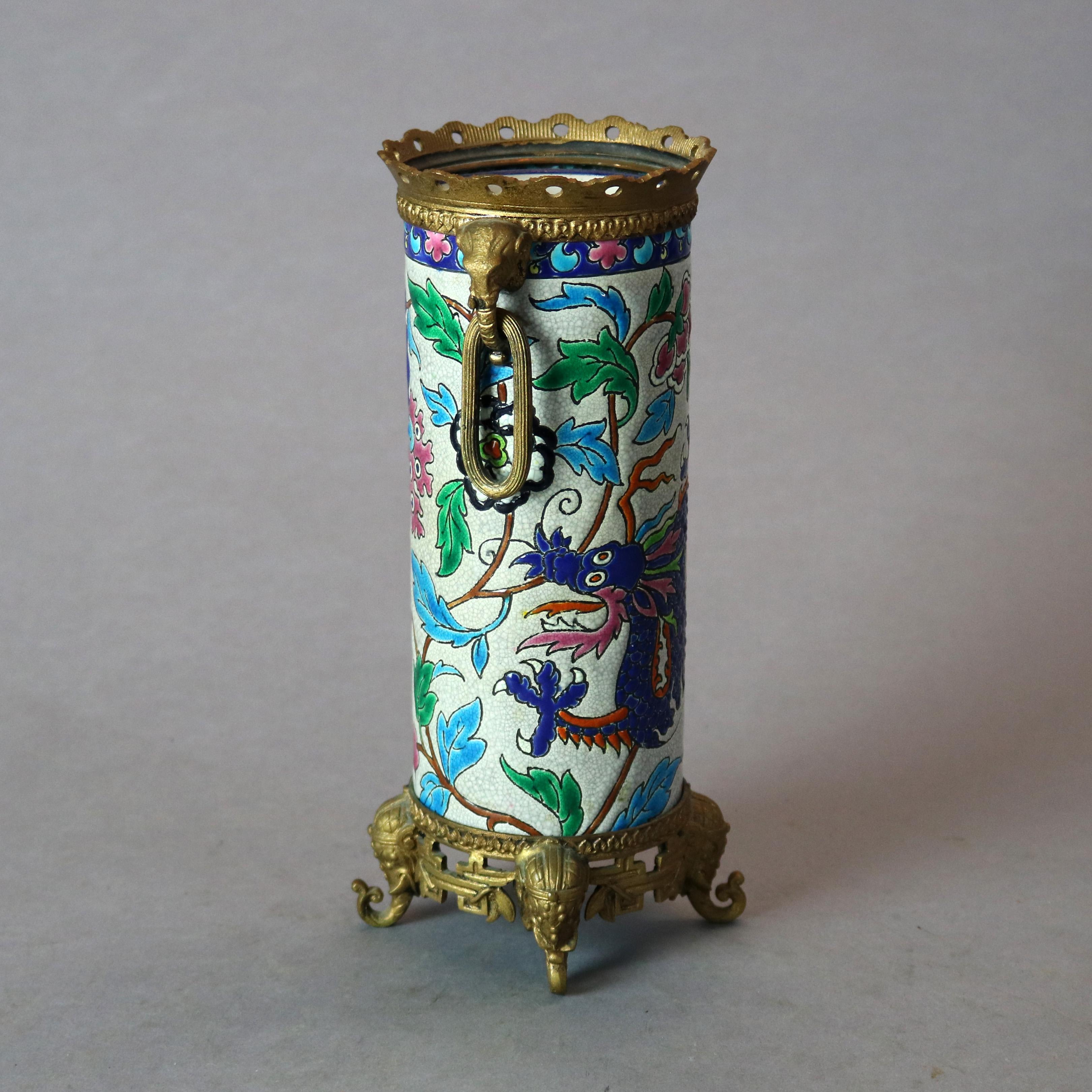 An antique French vase by Longwy Pottery offers enamel Chinoiserie decorated allover garden scene with dragon and cast figural bronze elephant double handles, raised on cast foliate plinth with elephant form feet, signed on base as photographed,