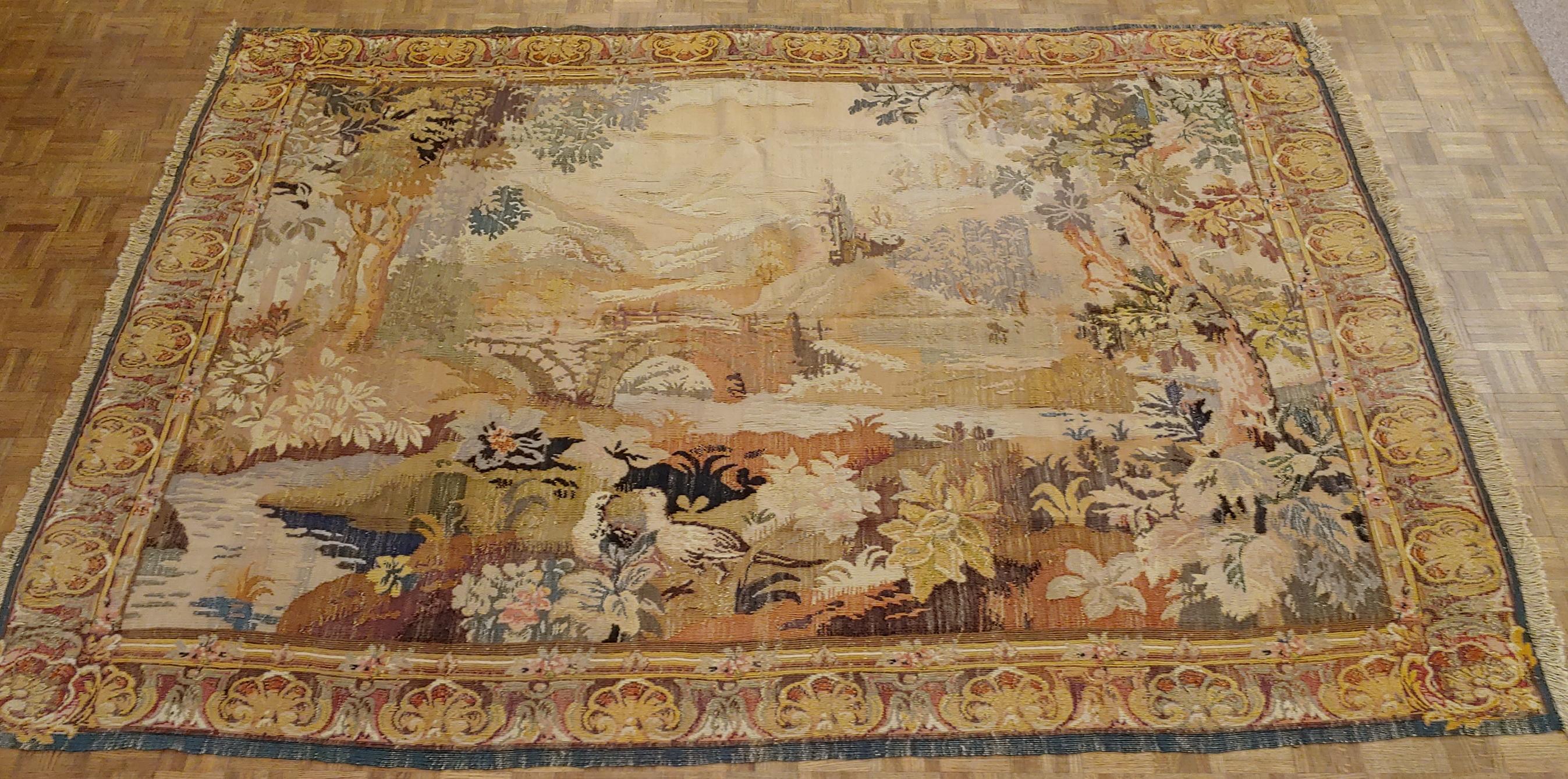 This is an exquisite French loomed tapestry. These tapestries were hand loomed in the early 20th century to compete with the handwoven Aubusson and Flemish tapestries. This forest scene is decorated with a beautiful two doves and mountains in the