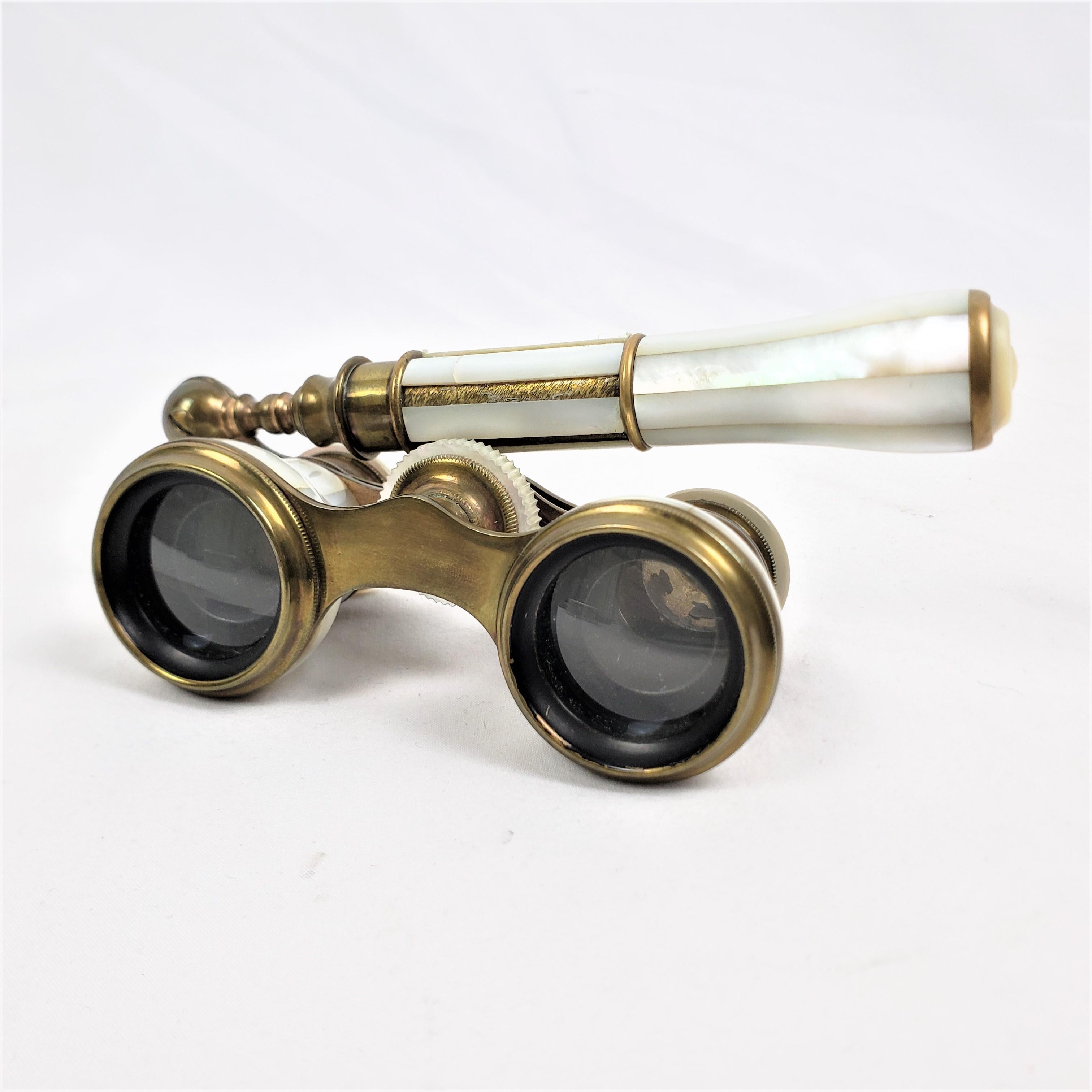 This pair of antique lorgnette opera glasses were made by LeRoy of France in approximately 1880 in the period Victorian style. These binoculars are composed of brass with very good optical glass and decorated with mother of pearl. These opera