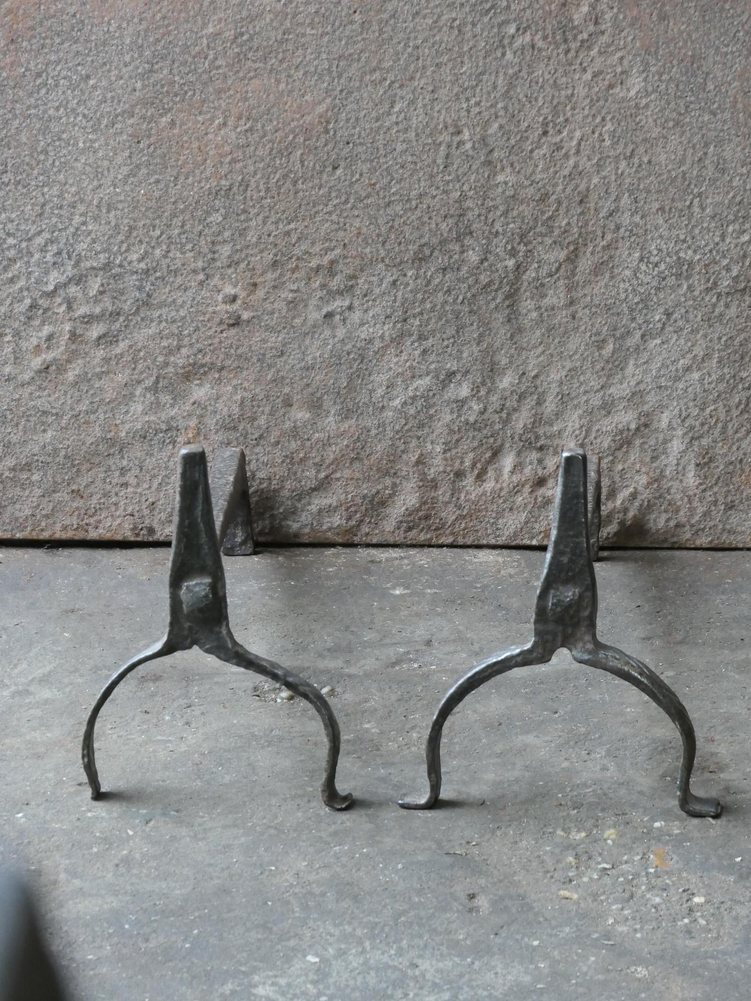 Hand forged and hand carved 17th century French andirons made of wrought iron. The style of the andirons is Louis III. They are in a good condition.