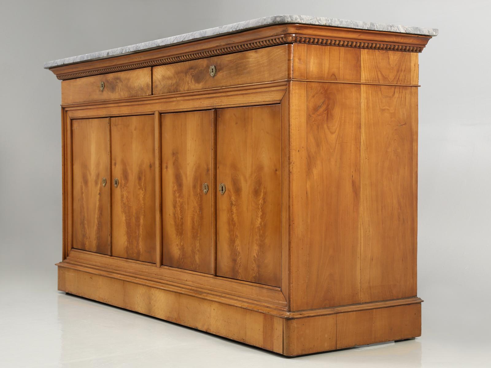 Original antique French Louis Philippe 2 drawer over 4 door configured antique French buffet or sideboard. Two large drawers sit over four exquisite and breathtaking doors (all locking), that rest elevated on a substantial and regal base. One neat