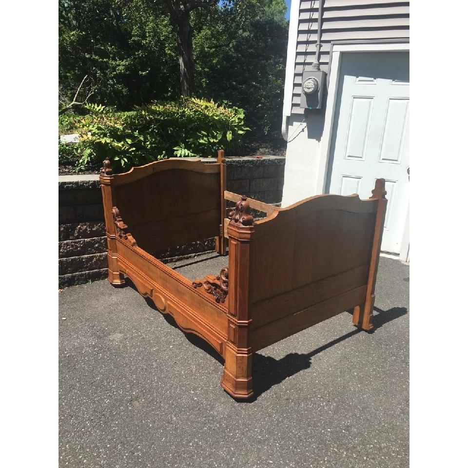 Stunning 19th century French daybed. Imported from France, this daybed is made of solid cherry wood and features a dramatic front rail with finely carved floral and scroll work. This piece may be used as a bed or a sofa, and it will require a custom