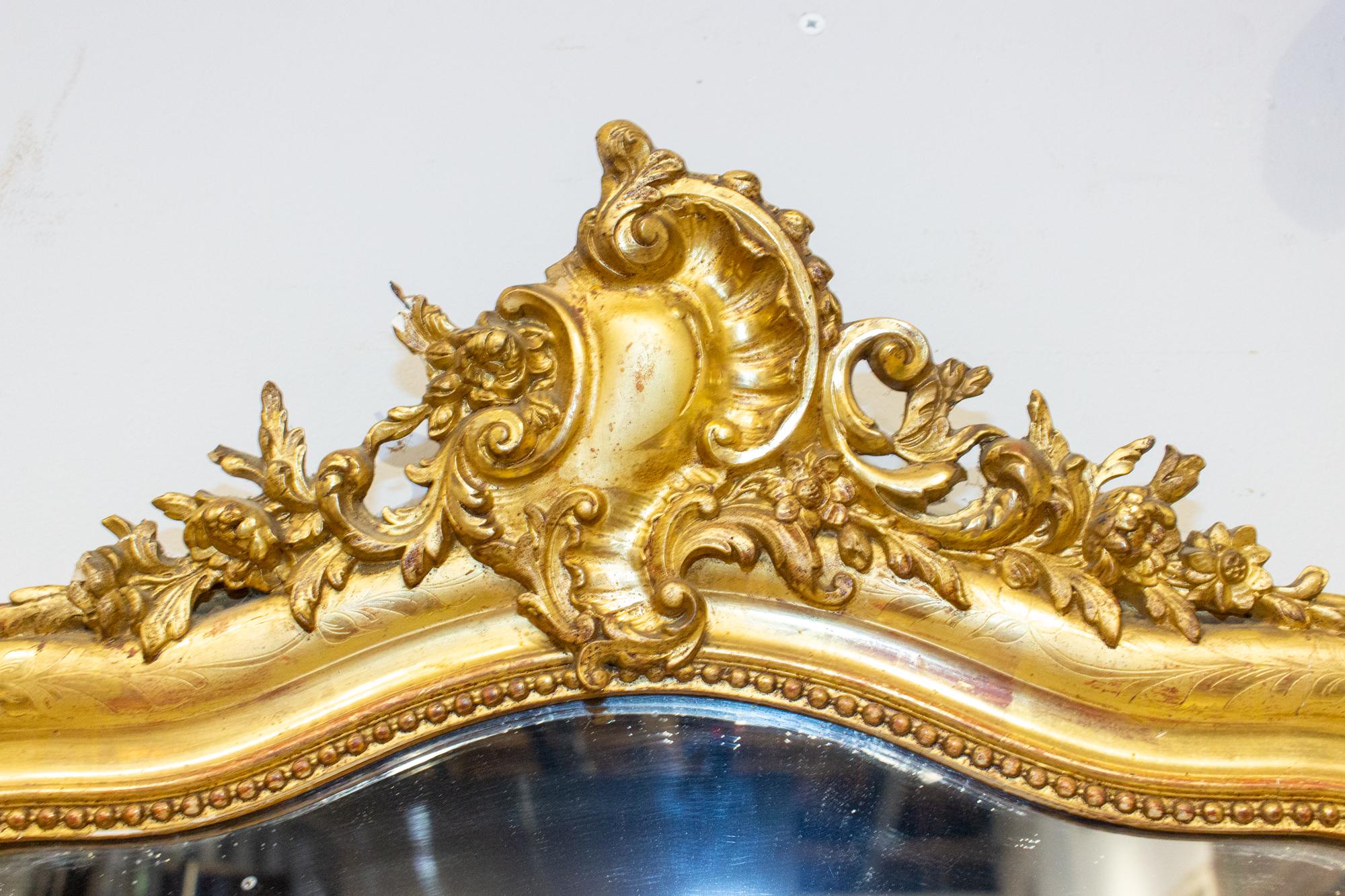 Another stunning antique French Louis Philippe mirror with cartouche detail in warm gold gilt finish, this mirror is a good vanity or powder room sized piece with beautiful antique mirror. There is quite a bit of age to the glass, but not too much,