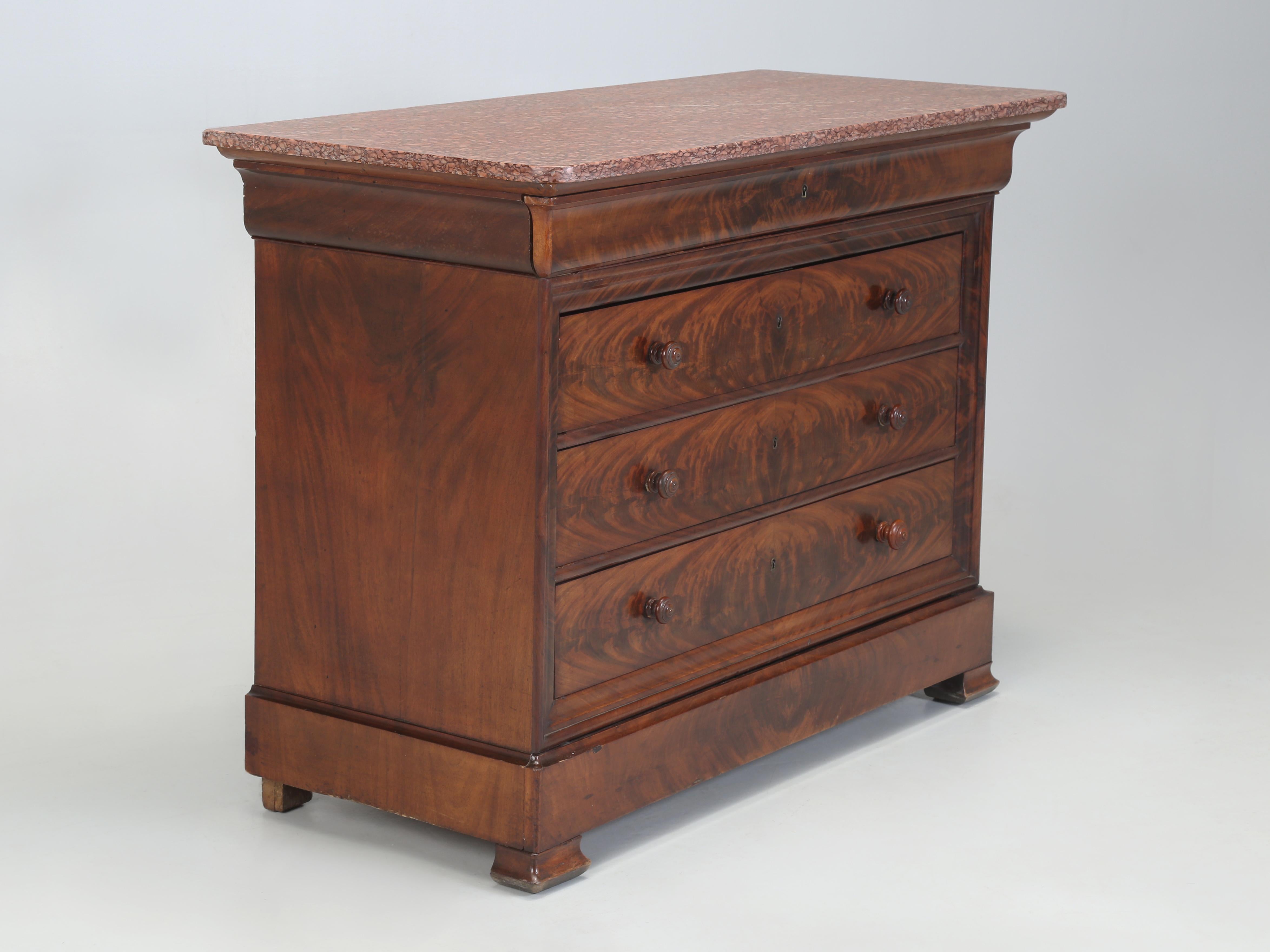 Antique French Louis Philippe Mahogany Commode with a Marble Top. The beautiful Crotch Mahogany has been carefully book-matched and appears to be all original. Our Old Plank Restoration Department went over the Antique French Chest of Drawers,