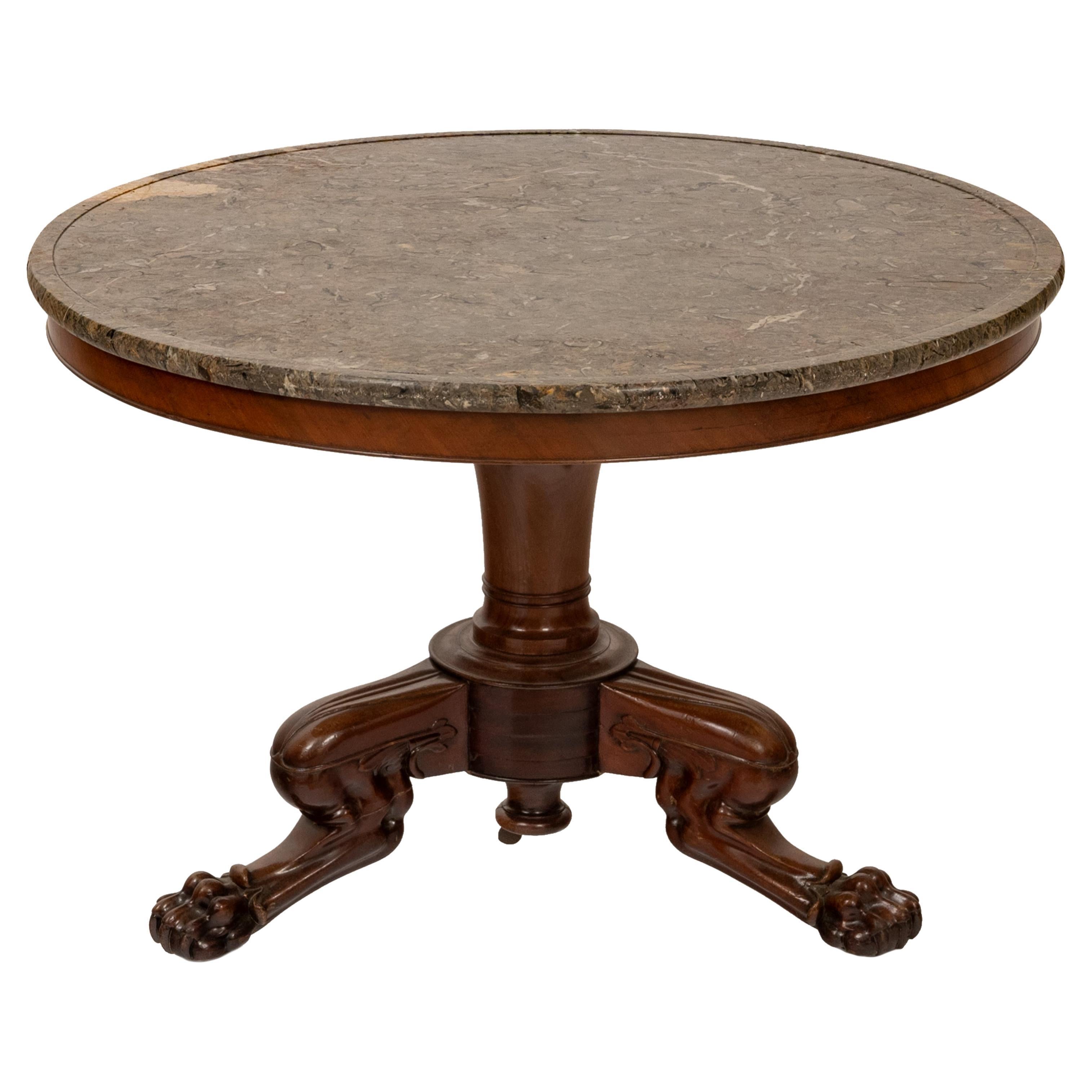 A good antique French carved mahogany & marble topped Louis Philippe center table, circa 1850.
The table having a variegated round marble top over a carved pedestal base, the table raised on a tripod base with carved lion's paw feet.
Condition is