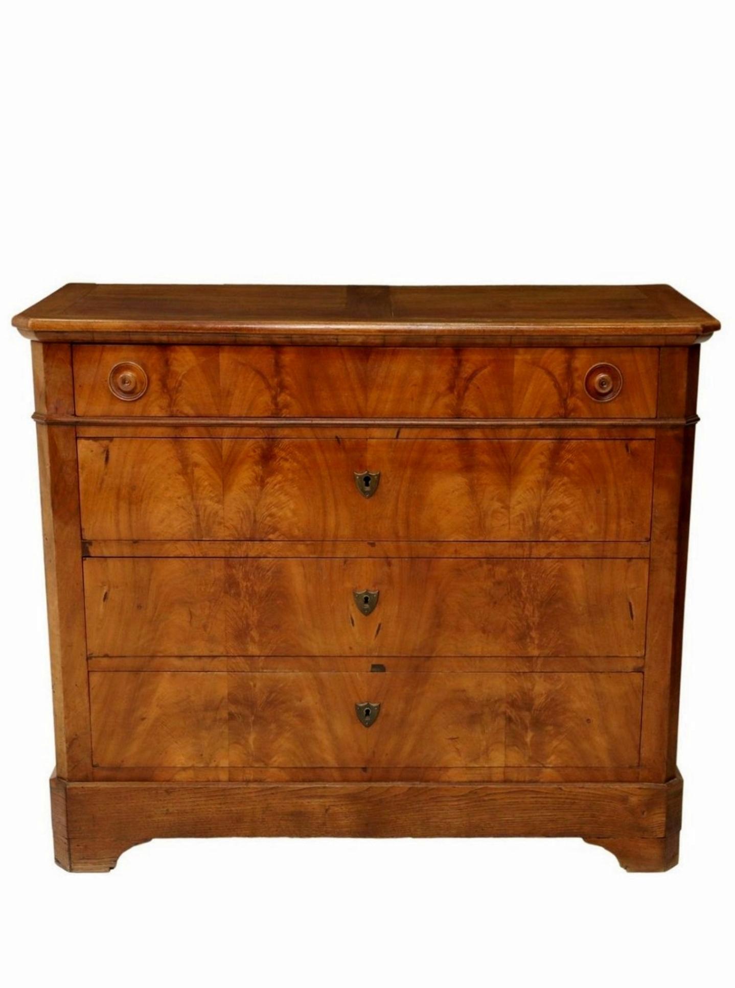 A classic French Louis Philippe Period (1830-1848) chest of drawers.

Hand-crafted in France in the mid-19th century, featuring bookmatched highly figured crotch flame mahogany and warm rich walnut, high-quality solid wood construction, having a