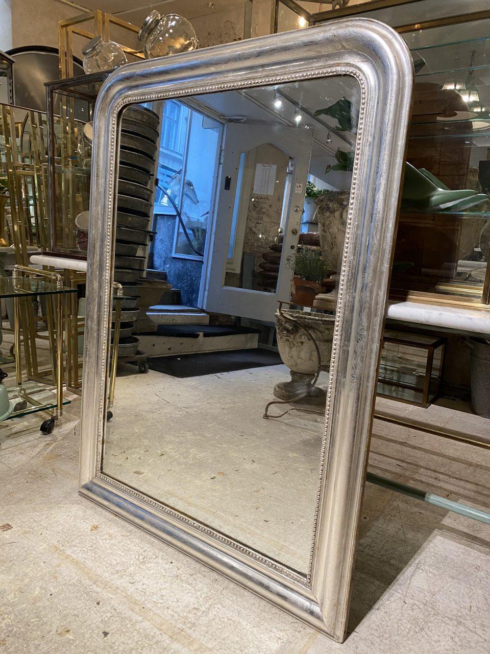 Beautiful and rare antique French Louis Phillipe silver mirror from the 1860s. Louis Phillipe mirrors are characterized by their curvaceous wide frames with rounded corners and wonderfully elegant profiles. Often used on mantlepieces.

This piece