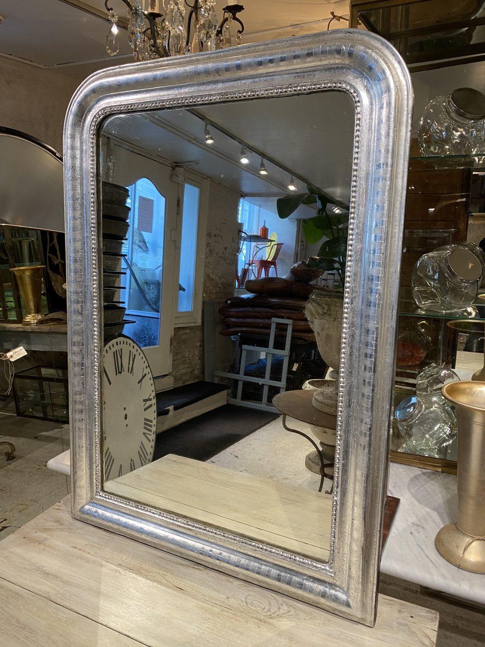 Beautiful antique French Louis Phillipe silver mirror from the 1860s. Louis Phillipe mirrors are characterized by their curvaceous wide frames with rounded corners and wonderfully elegant profiles. Often used on mantlepieces.

This piece still