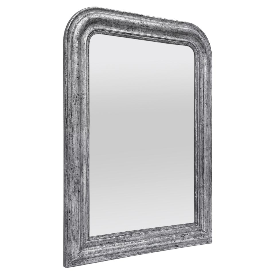 Antique French wall mirror in the Louis Philippe style, re-gilded with patinated silvered leaf. Antique frame width: 10.5 cm / 4.13 in. Modern glass mirror.