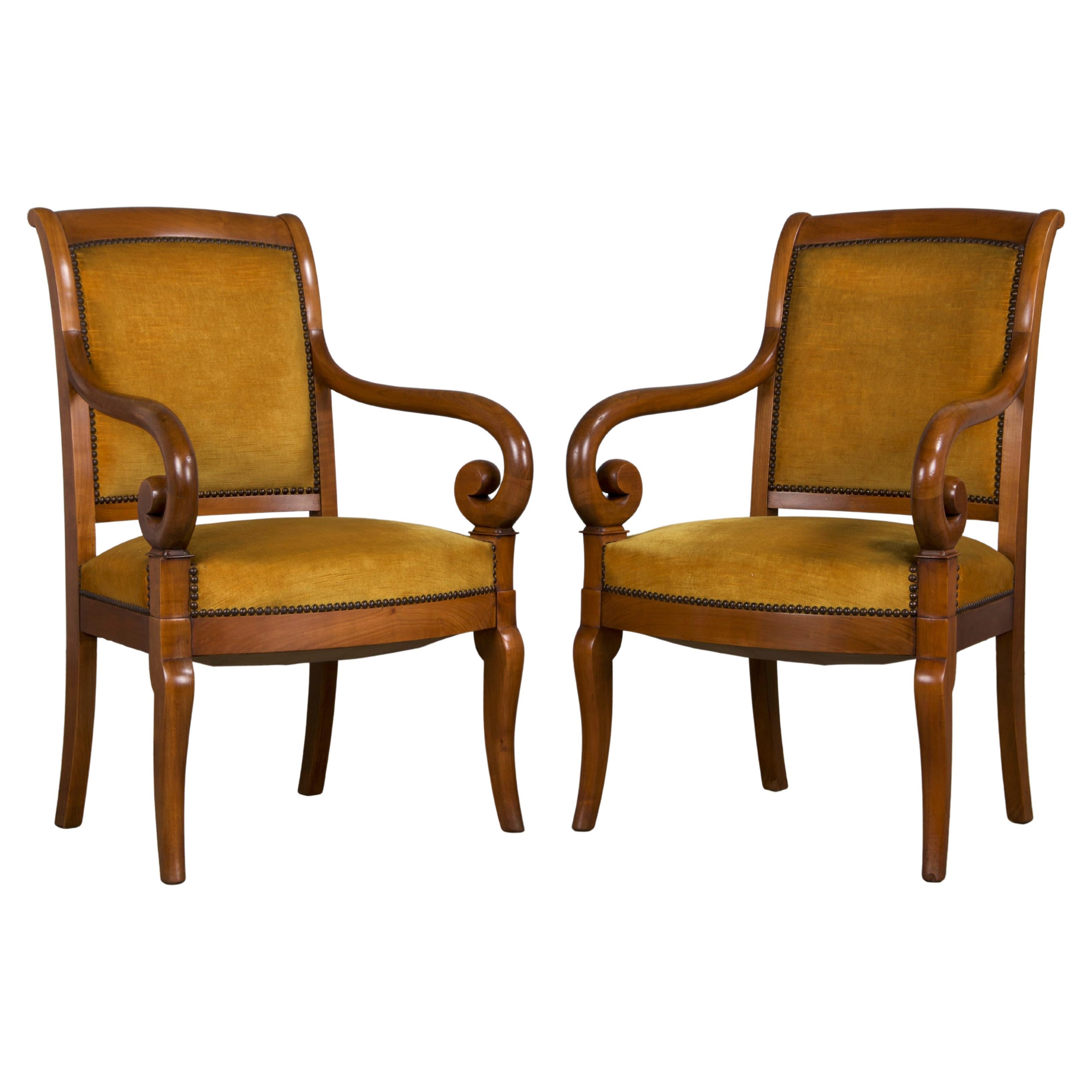 An elegant pair of late 19th-century French armchairs made in Louis Philippe style, sourced from Provence, France. These beautifully hand-carved chairs are made from solid walnut, showcasing a rich honey-brown patina that has naturally aged over