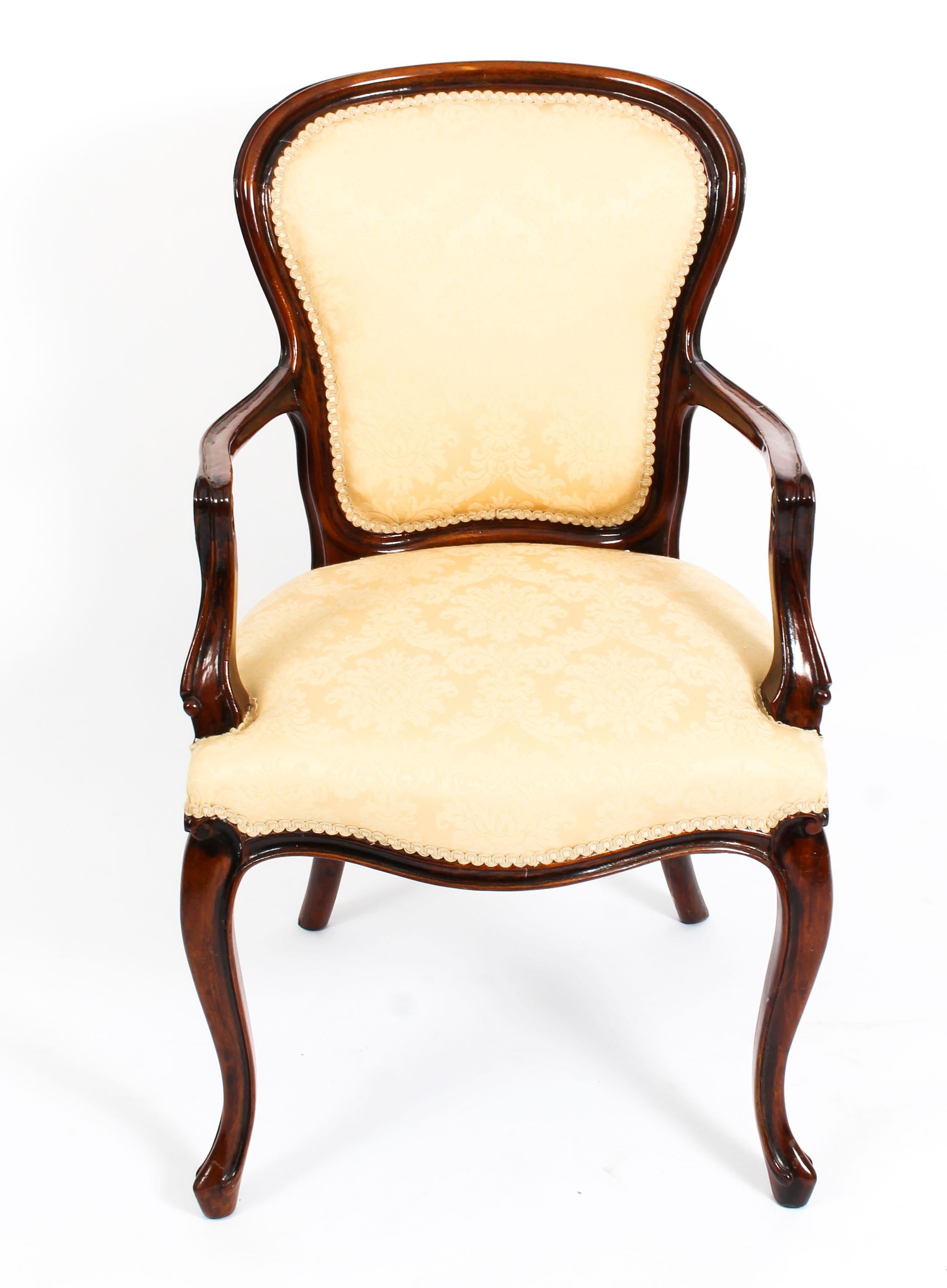This is a beautiful antique Louis Revival mahogany armchair, dating from the late 19th century.

It has been skillfully carved from solid mahogany and beautifully reupholstered in gold damask.

It has been expertly carved with a shaped