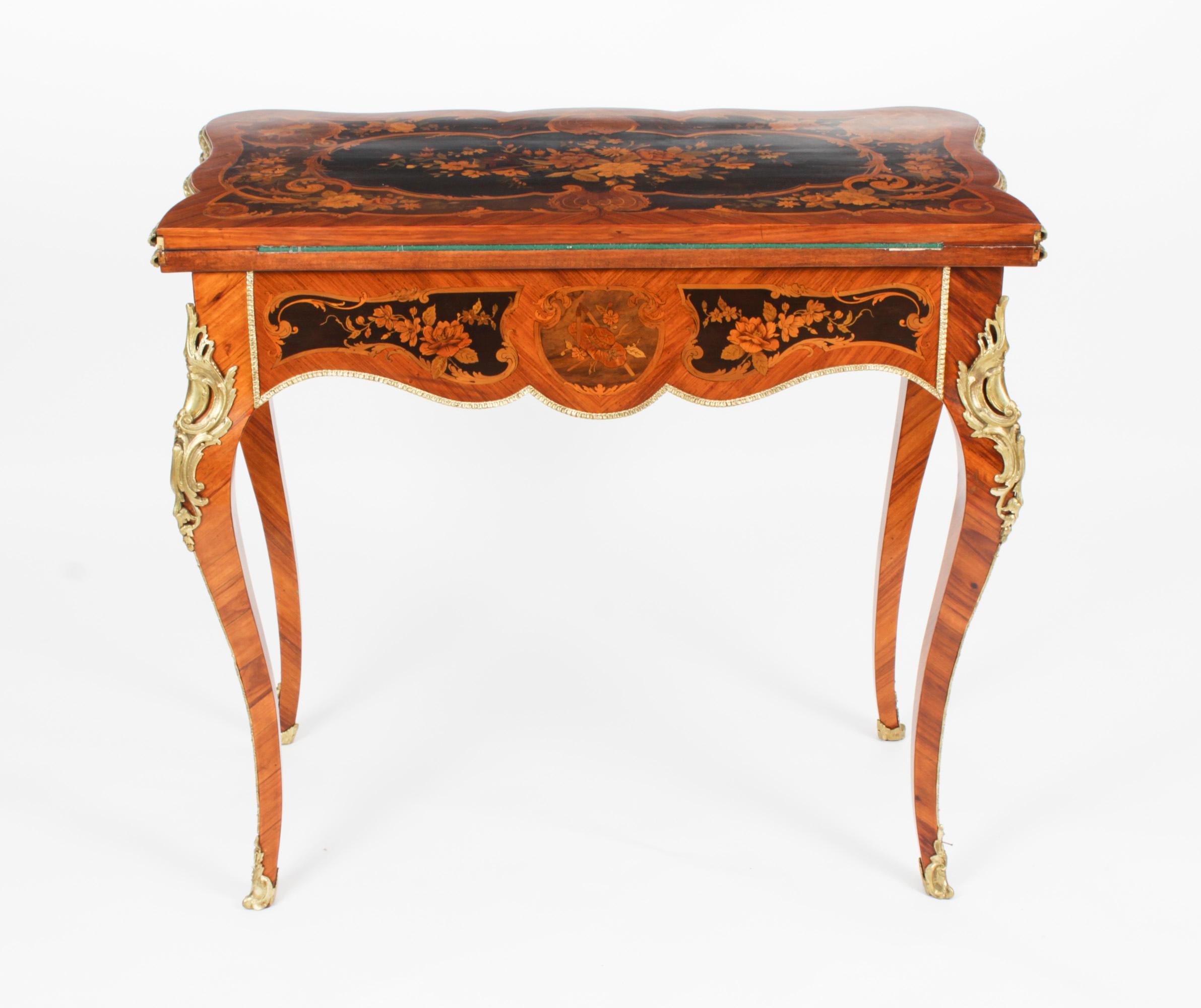 This is a stunning 19th century antique French Louis XV Revival ormolu mountd wood and floral marquetry shaped rectangular card table, circa 1870 in date.
 
The shaped top has banded marquetry inlay encompassing an exquisite floral marquetry bouquet