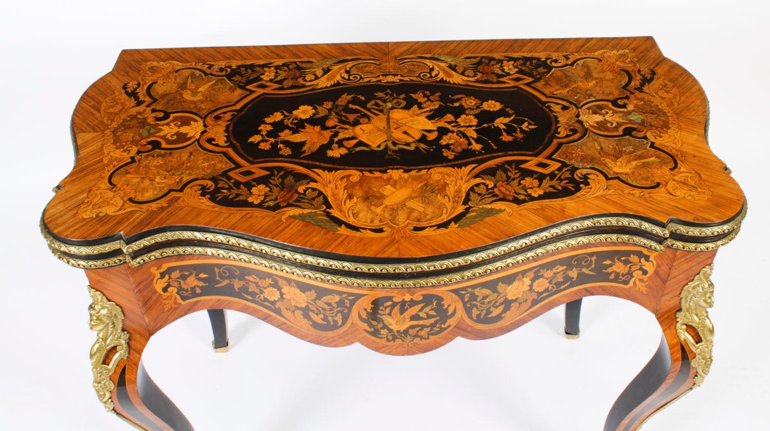 This is a stunning 19th century antique French Louis XV Revival ormolu mountd floral marquetry shaped rectangular card table, circa 1870 in date.
 
The shaped top has banded marquetry inlay encompassing an exquisite floral marquetry bouquet of