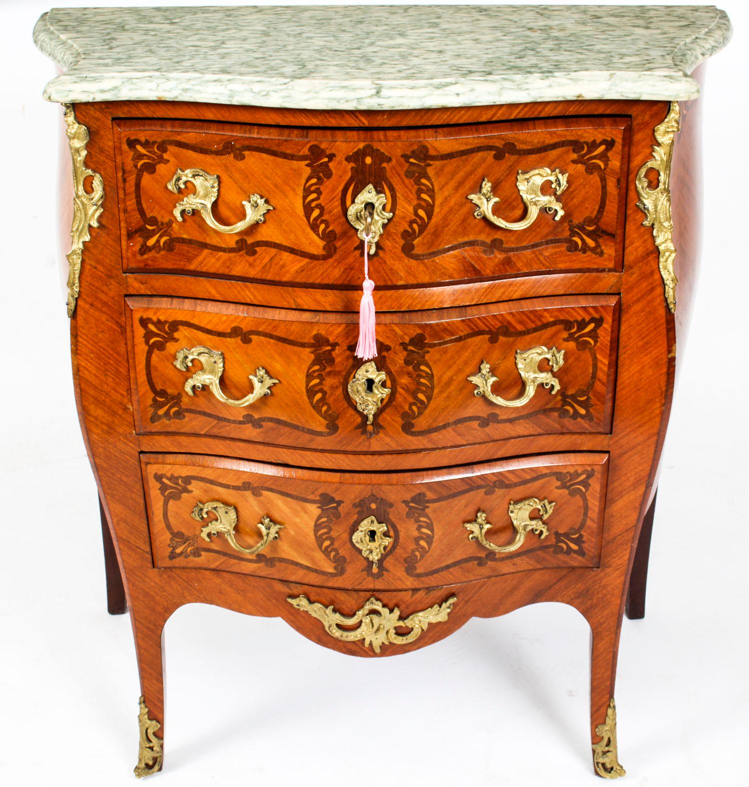 This is a stunning antique French walnut and marquetry Louis Revival serpentine fronted commode, circa 1880 in date. 

This gorgeous commode features a Gris St.Anne shaped marble top above three drawers for ample storage, and was inspired by the