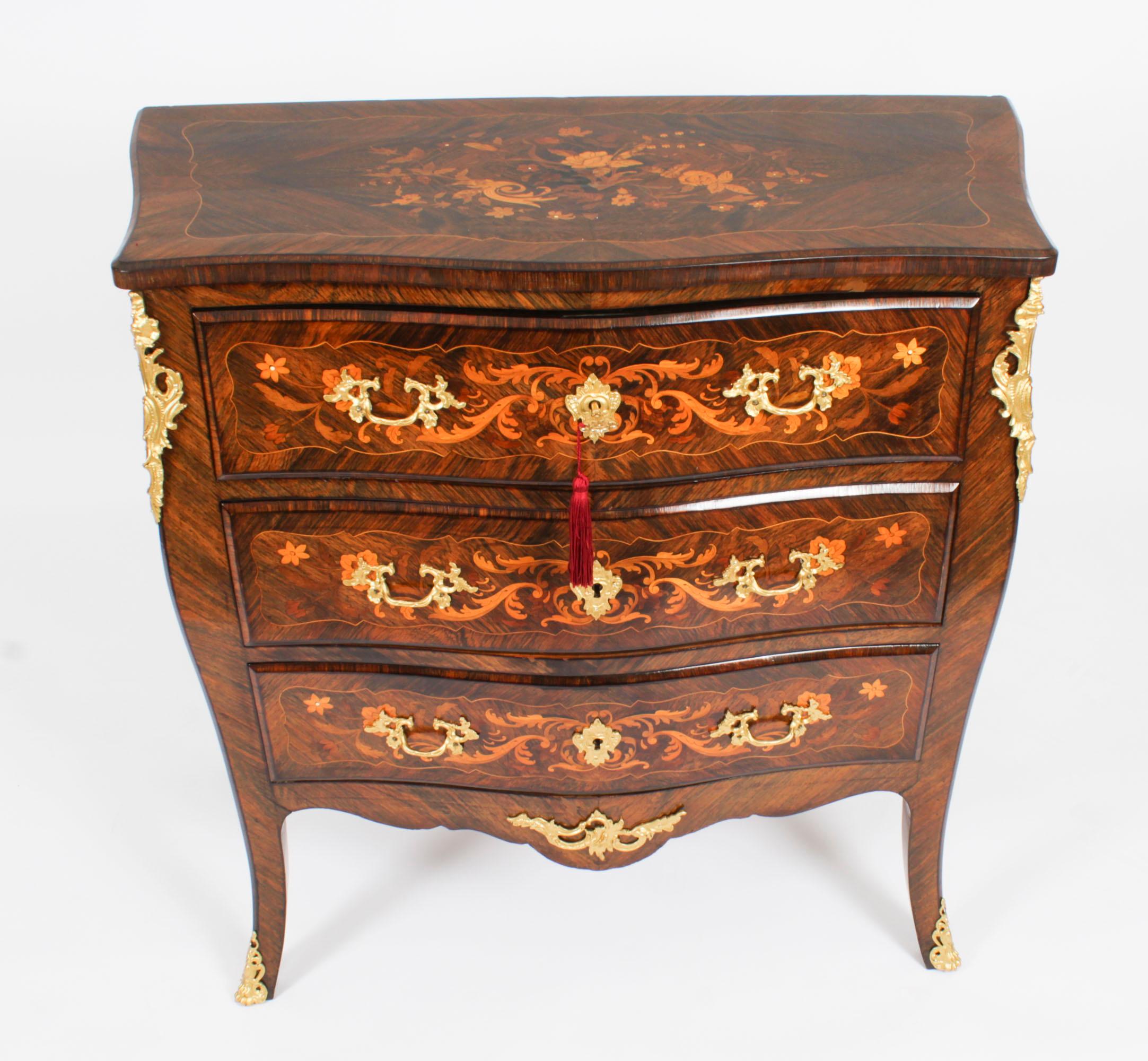 This is a stunning antique French Louis Revival marquetry and ormolu mounted wood serpentine commode, circa 1880 in date.
 
The serpentine top with a moulded edge over three long drawers and a shaped apron, on tapered slightly outswept legs, with