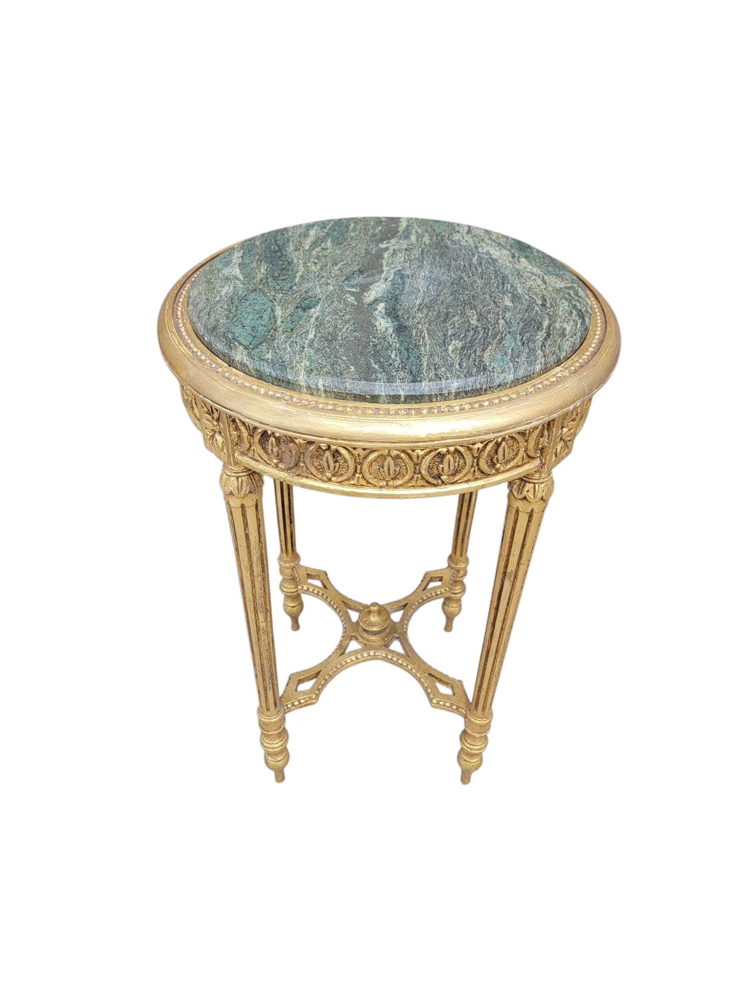 Antique French Louis Style Fluted Leg Side Table with an Inset Green Italian Marble Top and Gold Gilded Carvings

Elevate your living space with this exquisite antique French Louis style fluted leg side table, a stunning blend of elegance and