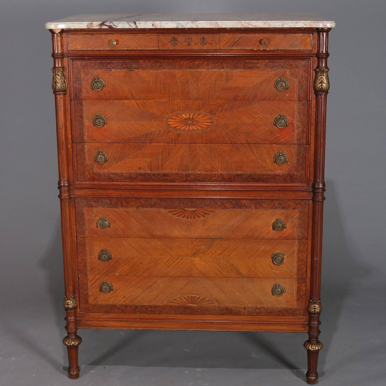 Antique French Louis XVI style high chest features case with shaped marble top above bookmatched feather patterned drawers flanked by carved columns with gilt acanthus decoration, drawers are burl framed and banded having central inlaid pertera, top