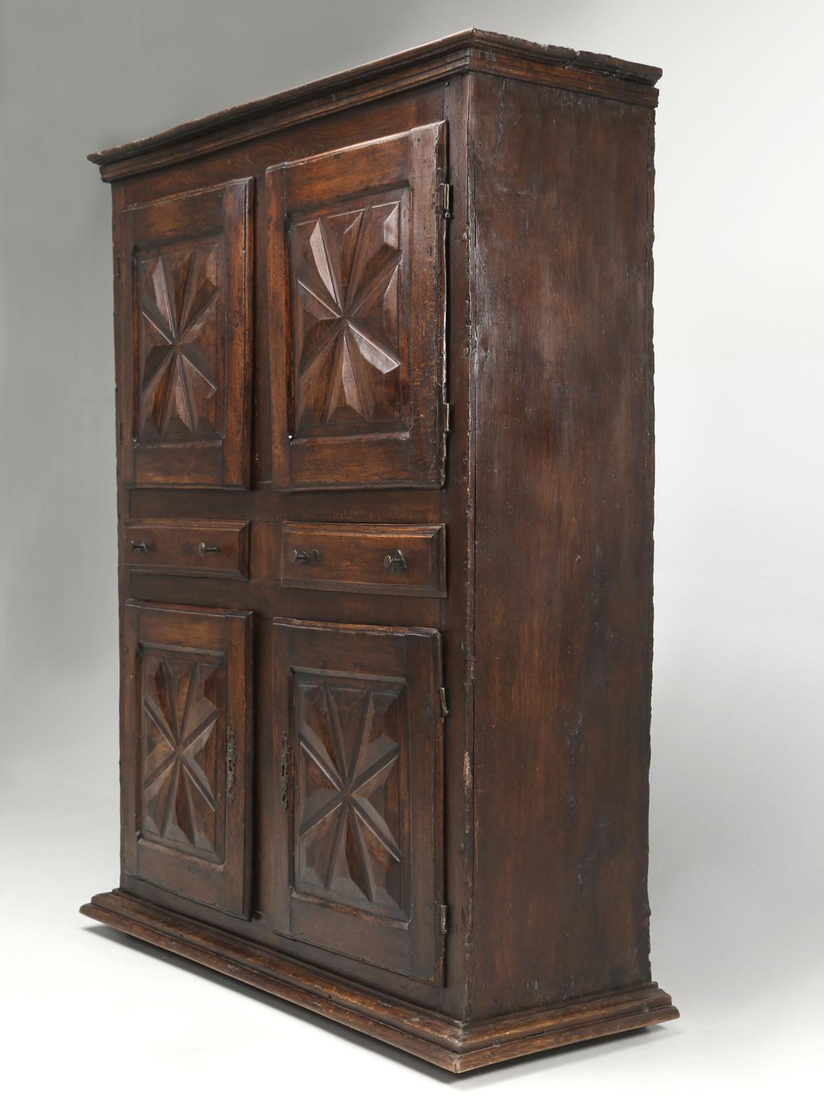 Very authentic 300-year-old French 4-door cupboard, with 2-drawers, or some might call it an armoire. In truth, the 4-doors make more a much more useful cabinet. The original patina or wear would be impossible to fake and we have every reason to
