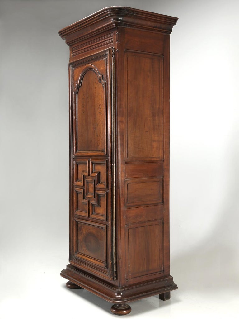 Antique French Louis XIII Style Bonnetière or small armoire. What makes this particular antique French petite armoire so unusual is the wood. Generally, one would expect to see oak, cherry or walnut. Our French armoire is actually constructed from