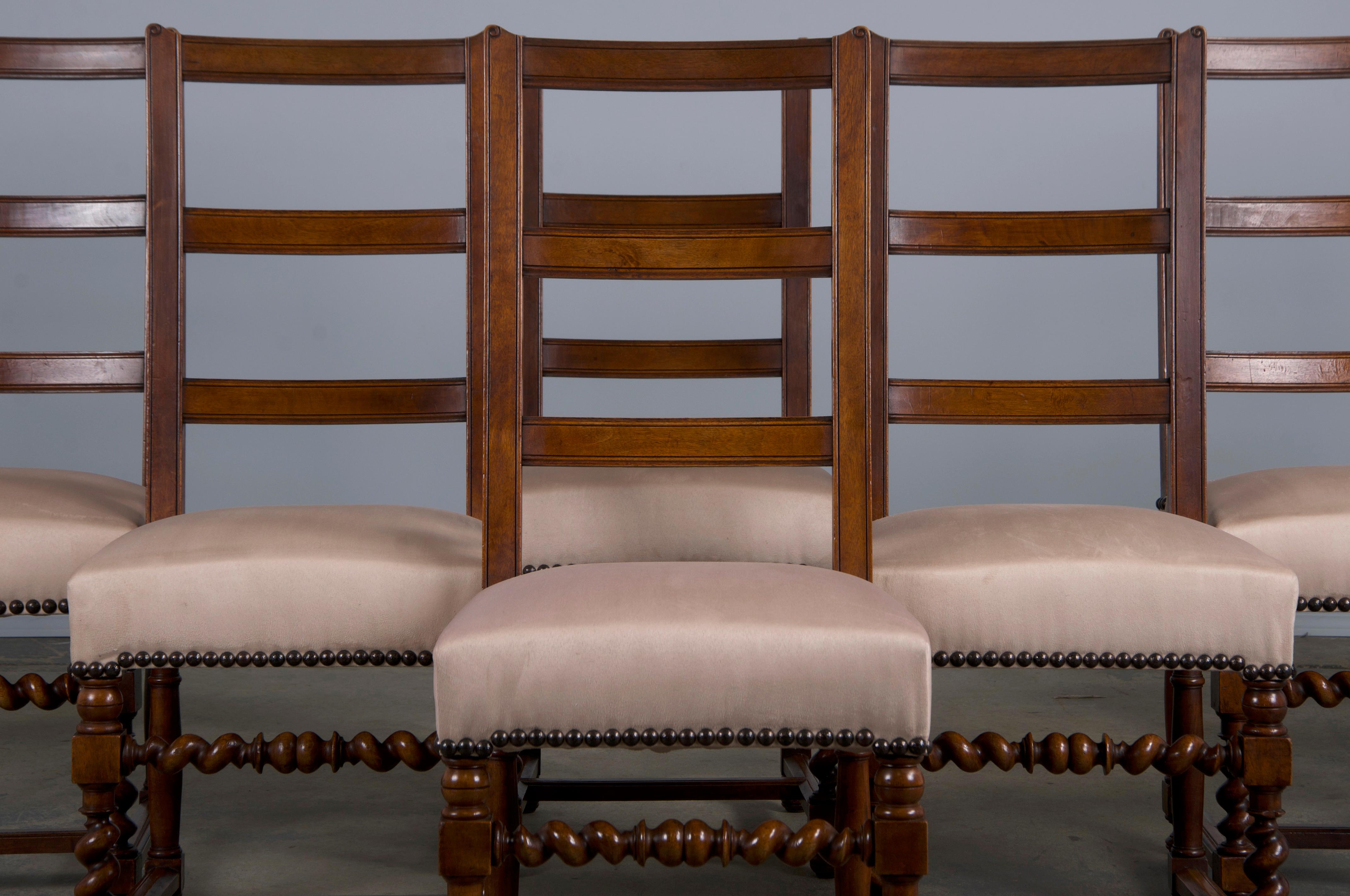 A handsome set of eight late 19th-century French dining chairs made in the style of Louis XIII, sourced from Provence, France. Beautifully hand-crafted from solid walnut wood featuring a tall ladder back frame. The chairs have been structurally