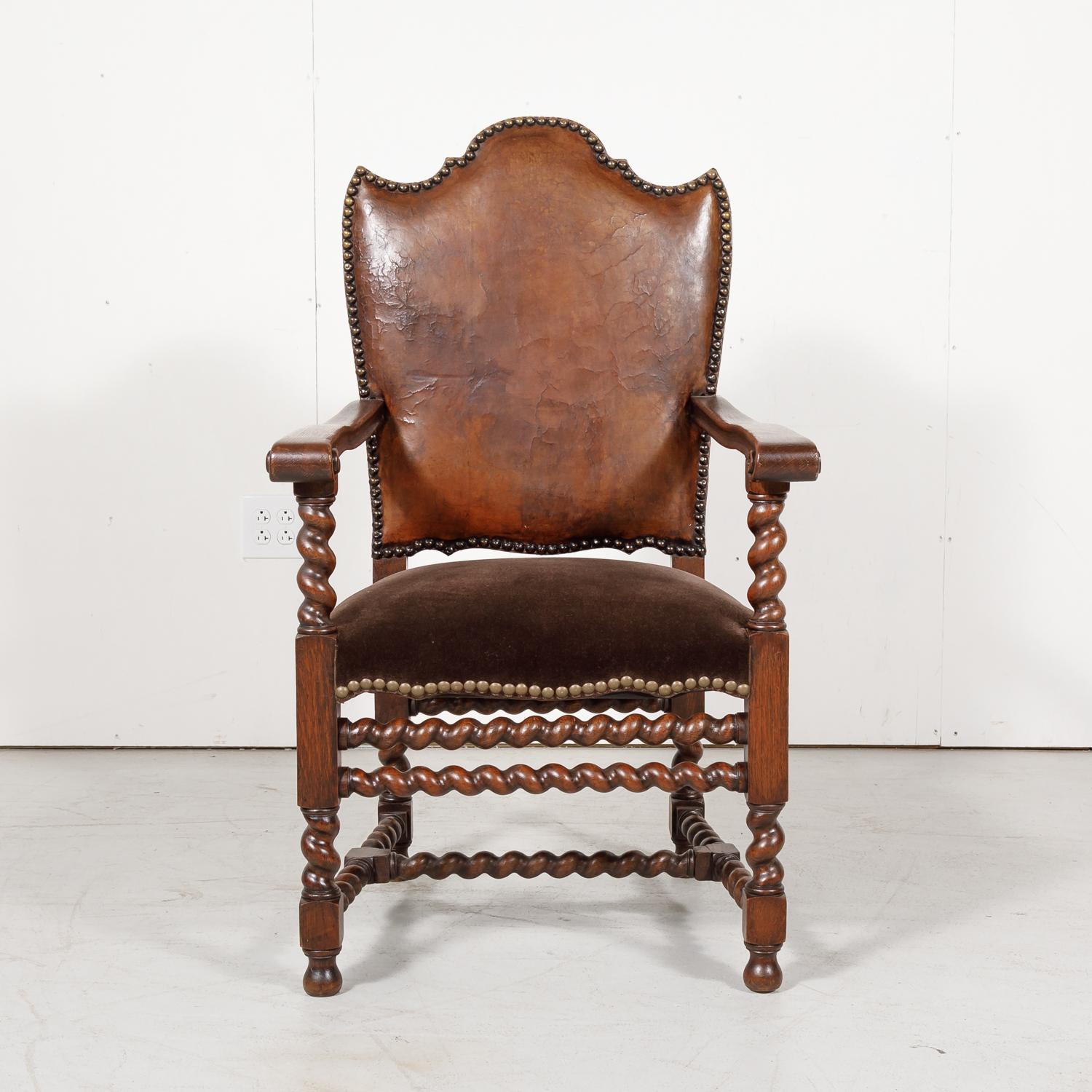 Antique French Louis XIII style barley twist armchair handcrafted and carved of old growth French oak by talented artisans in Bordeaux, having the original leather back and newly upholstered mohair seat with nailhead trim, circa 1860s. The stylized