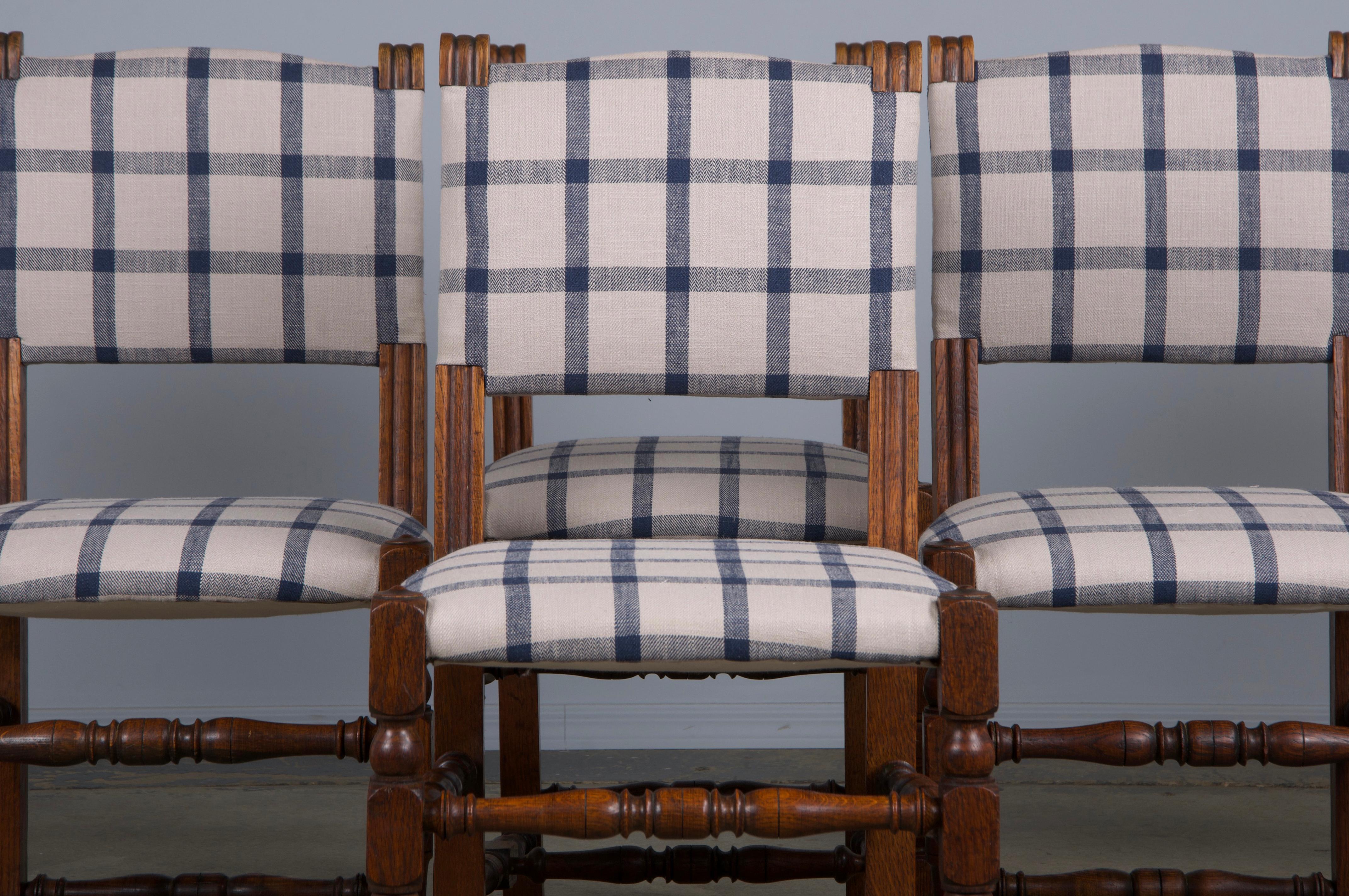 A charming set of six late 19th-century French dining chairs in the Louis XIII style, sourced directly from Provence, France. Expertly hand-crafted from solid oak, these chairs feature a handsome square back adorned with carved finials. They have