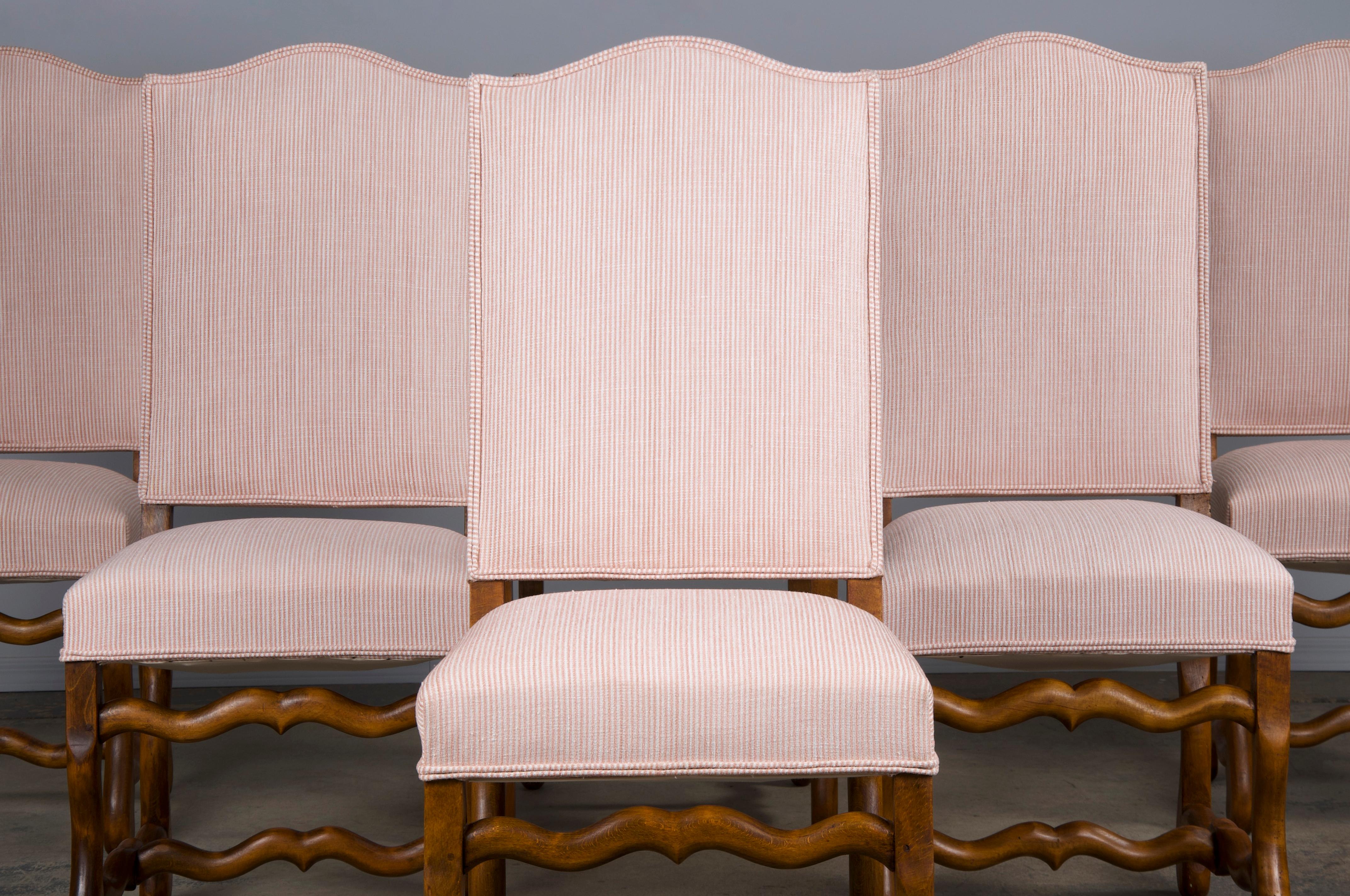 Antique set of six French dining chairs made in the style of Louis XIII style, sourced from Provence, France. Beautifully hand-crafted from solid oak wood featuring an elegant chapeau de gendarme back frame. The chairs have been structurally