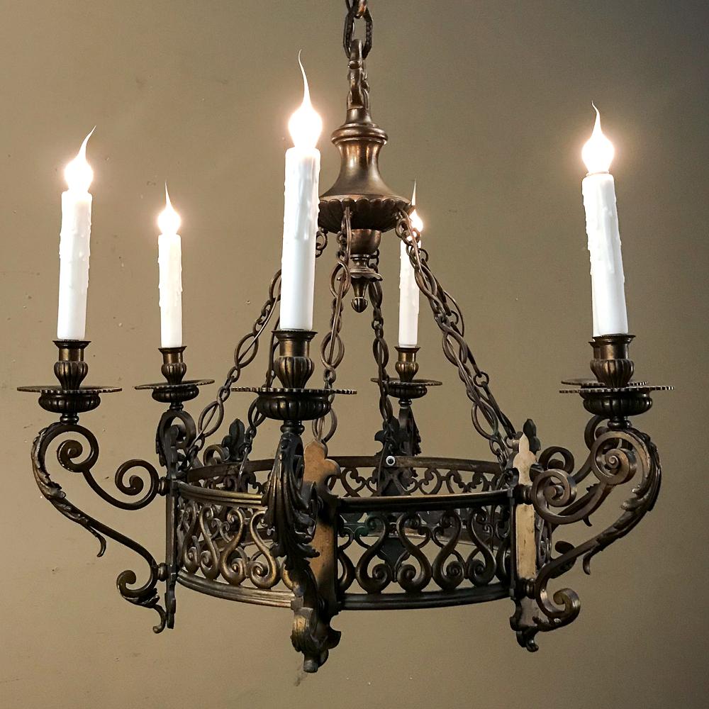Antique French Louis XIV bronze chandelier is a splendid example of Old World craftsmanship combined with the modern convenience of electric lighting to create a splendid ambiance for any room. Fine scrollwork, acanthus plume motifs, and finely