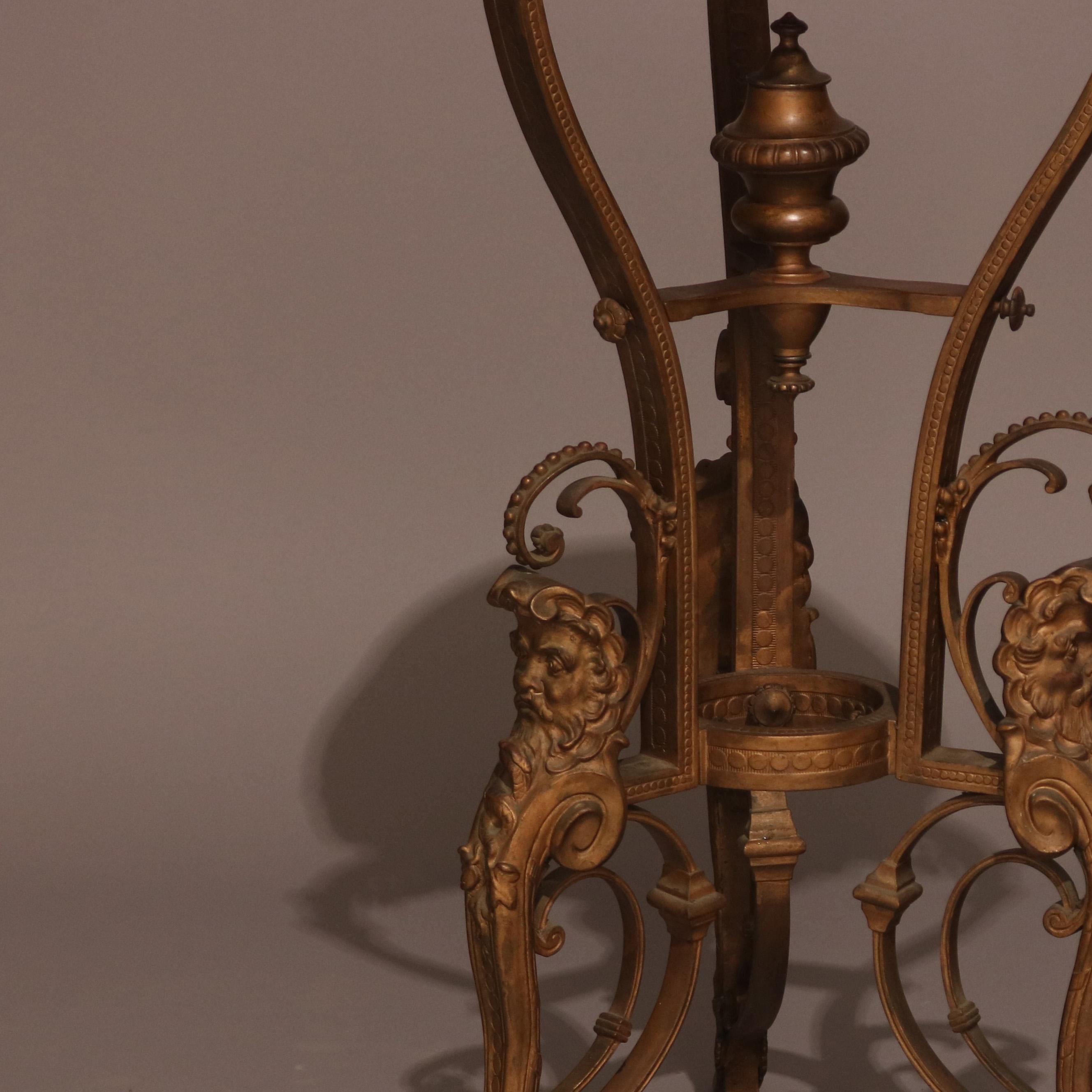 An antique French figural sculpture stand features cast gilt metal structure with marble top seated in frame with foliate border and surmounting scroll and foliate form tripod legs with sculptural masks, circa 1890.

Measures: 35.5