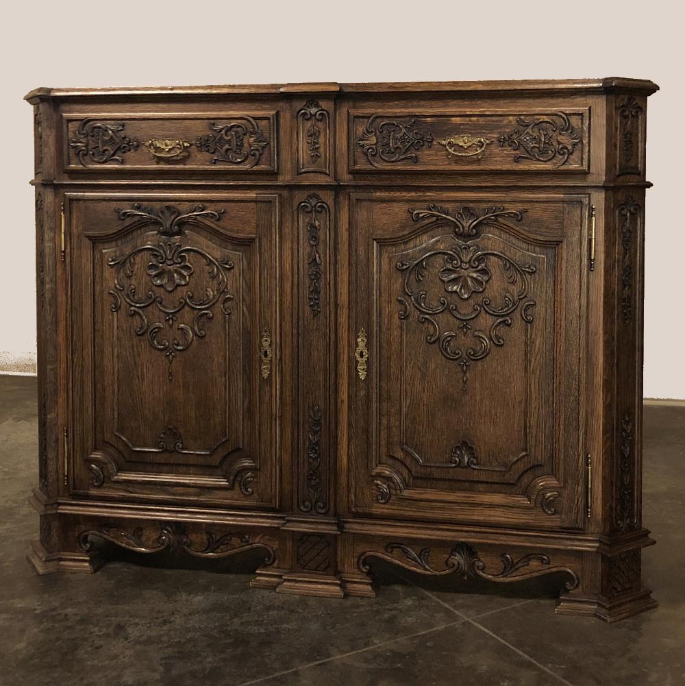 Antique French Louis XIV buffet is an amazing work of the cabinetmaker's art! The casework features mitered corners and a step-out center pilaster that creates a contour that is mirrored by the solid plank top. The drawers just below the top are
