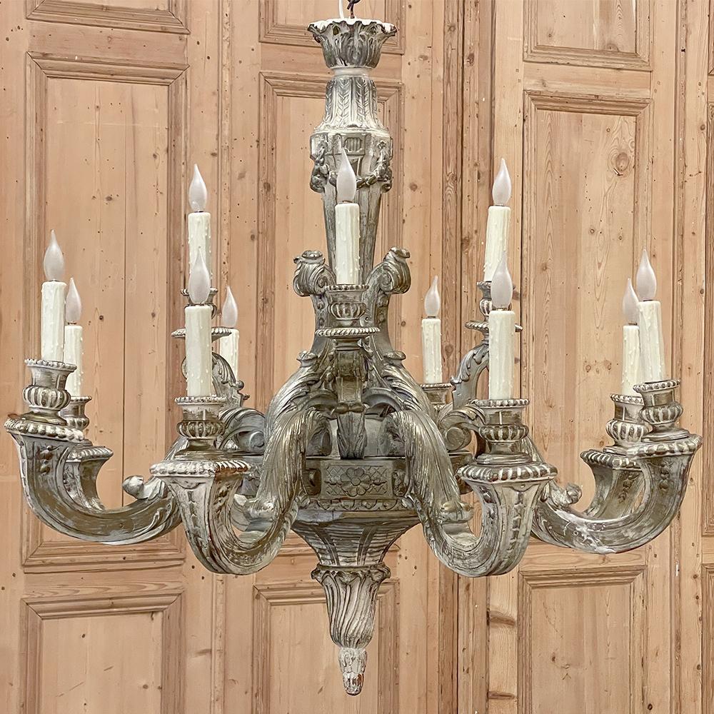 Antique French Louis XIV Carved & Painted Wood Chandelier features breathtaking artistry sculpted from solid wood and representing the epitome of style and grace that is the essence of the genre! The acanthus plume crown presides over the central