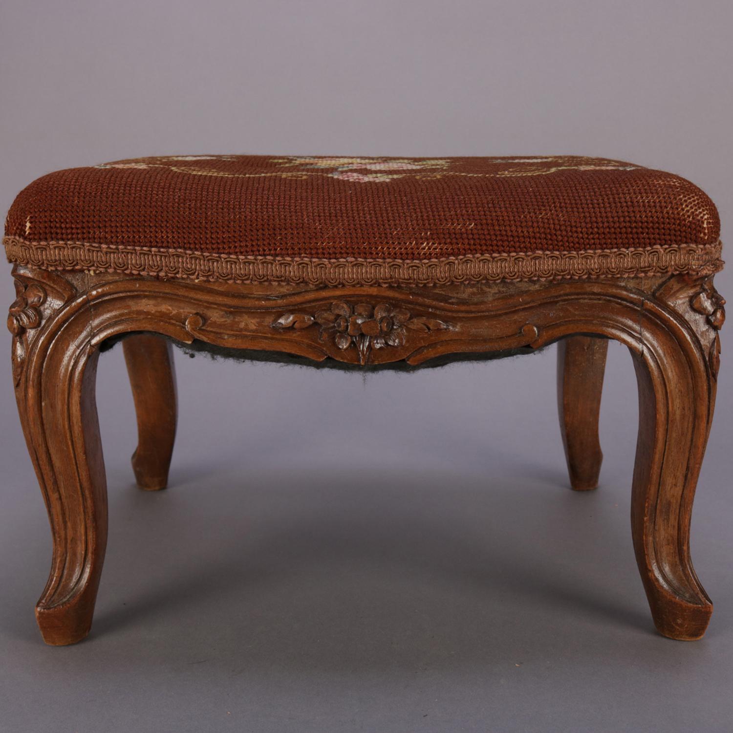 An antique French Louis XIV footstool feature floral tapestry seat on carved walnut base having cabriole legs, circa 1890.

Measures: 9.5