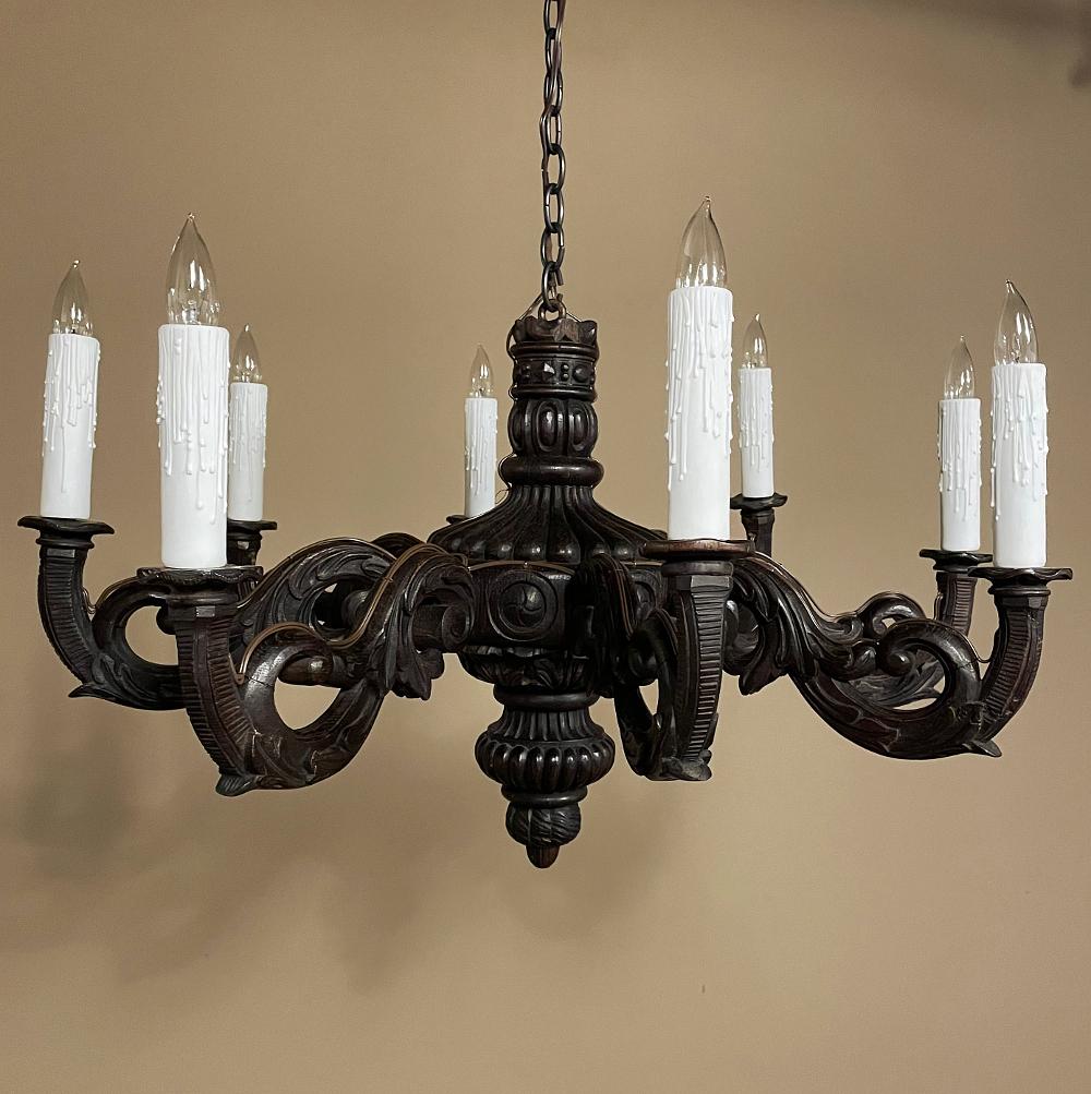 Antique French Louis XIV carved wood chandelier is a wonderful example of the style, featuring a boldly carved central shaft in an urn form with multiple tiered pendant below mounted to a large circular acanthus rosette. Just above the rosette is