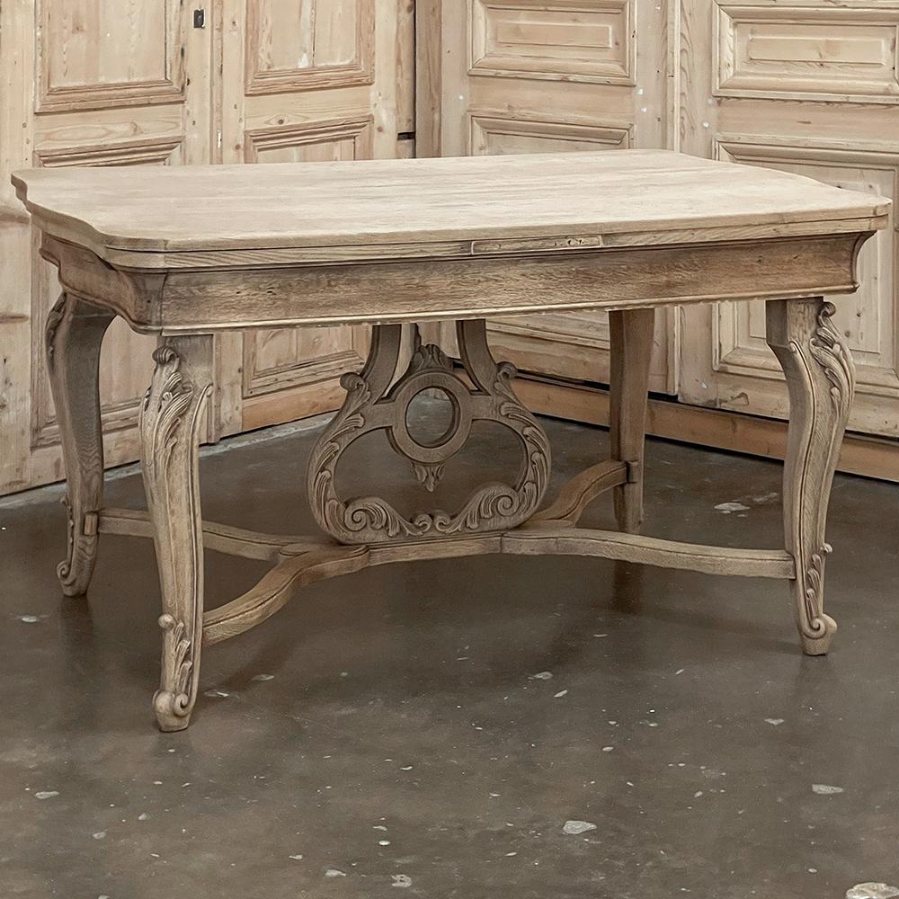 Antique French Louis XIV draw leaf dining table in stripped oak is an unusual example of the cabinetmaker's art! Crafted entirely from oak, it makes for a great compact table good for smaller dining rooms or breakfast areas, yet has two concealed