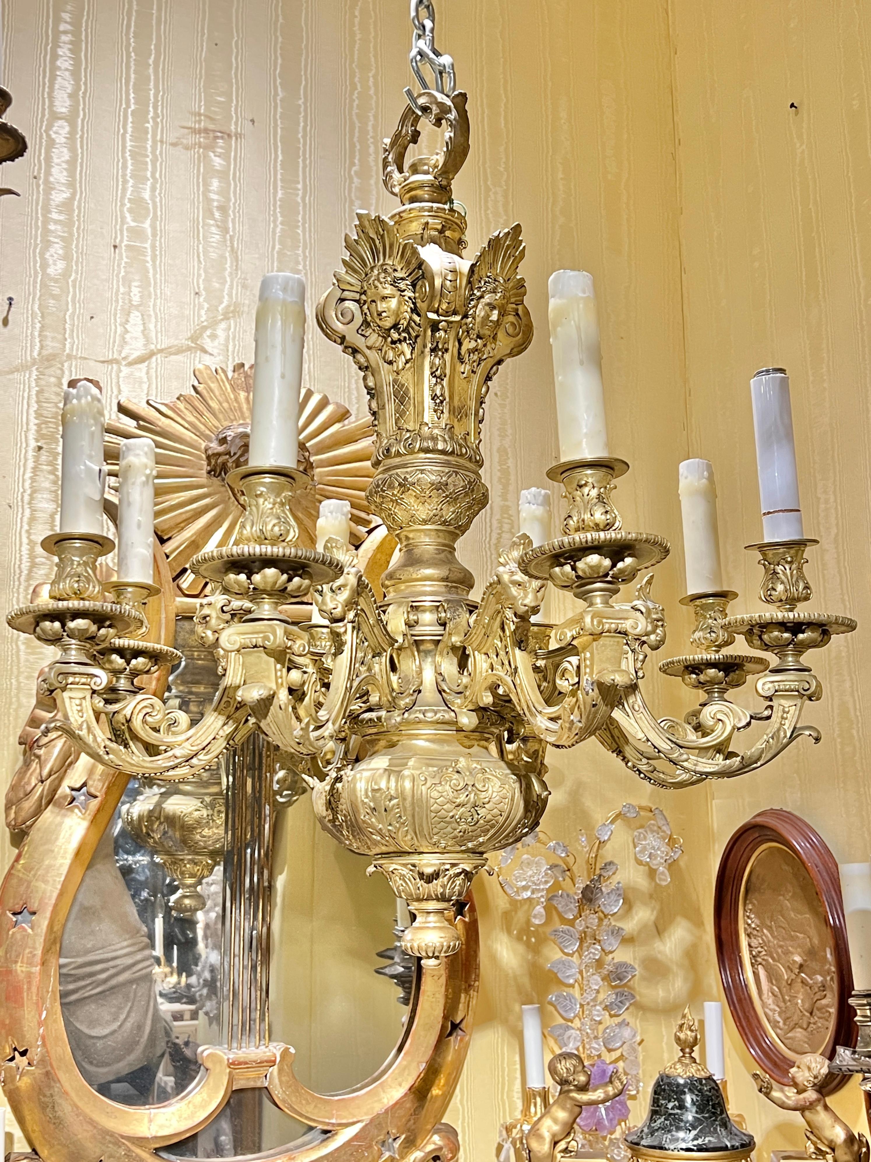 Antique (late 19th century) French Louis XIV style gilt bronze chandelier in the style of André-Charles Boulle (French, 1642 - 1732), later electrified with sockets, wiring and wax candle covers.