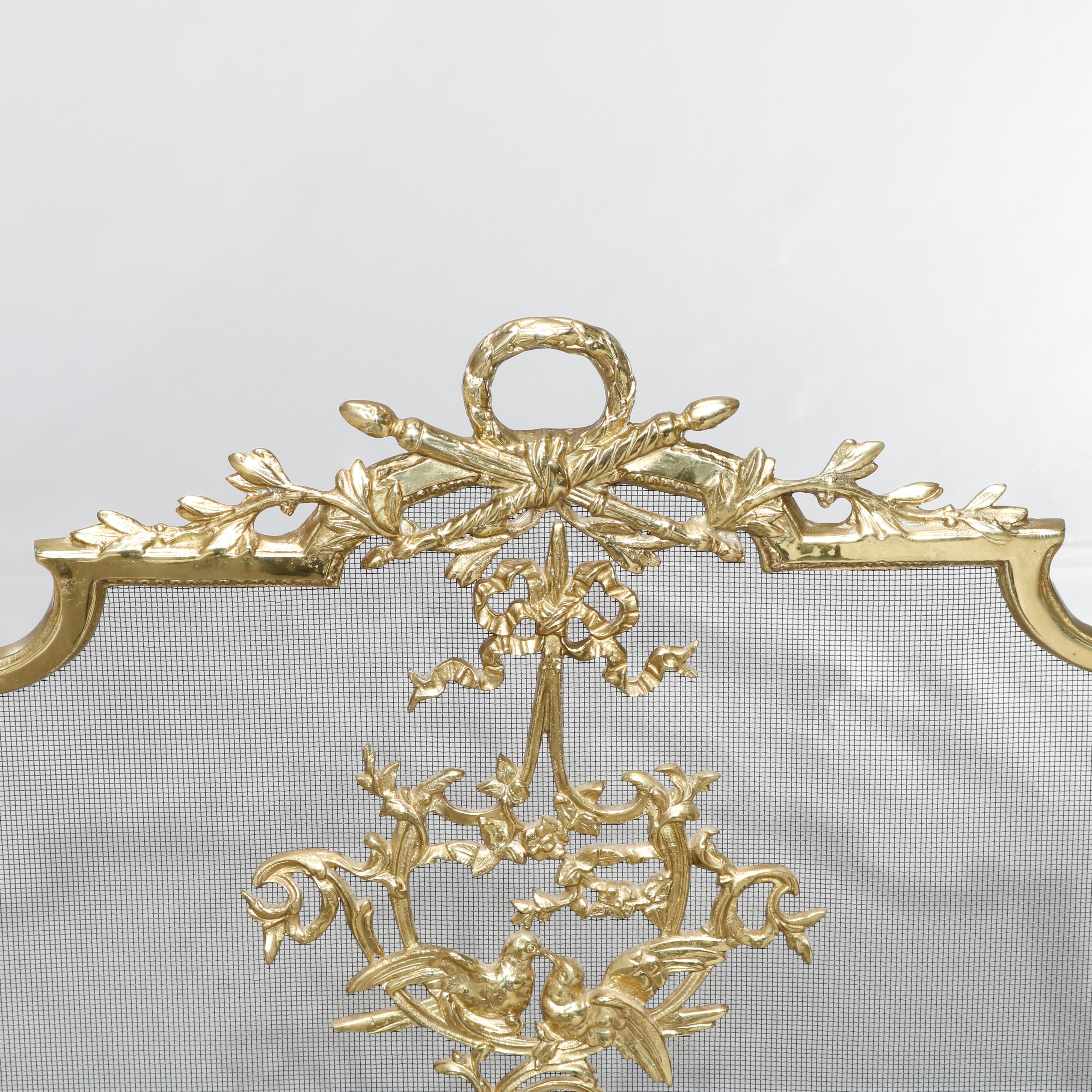 An antique French Louis XIV fireplace screen offers shaped gilt bronze frame with victory wreath finial, foliate elements and central reserve with birds, 20th century.

Measures: 27.5