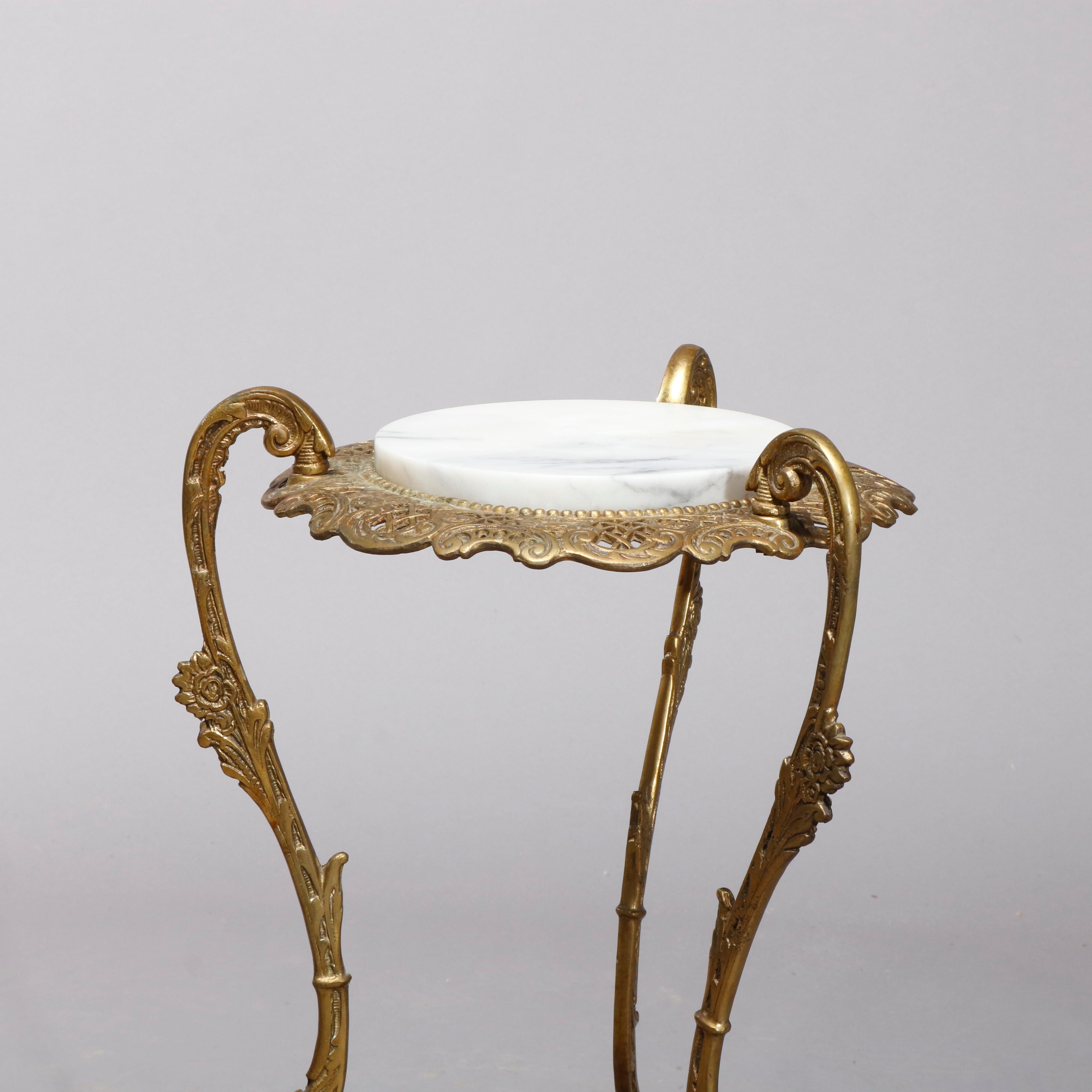 An antique French Louis XIV fern stand offers marble top surmounting gilt bronze base having pierced foliate frame raised on three foliate form cabriole legs with lower display, circa 1900.

Measures: 29.5