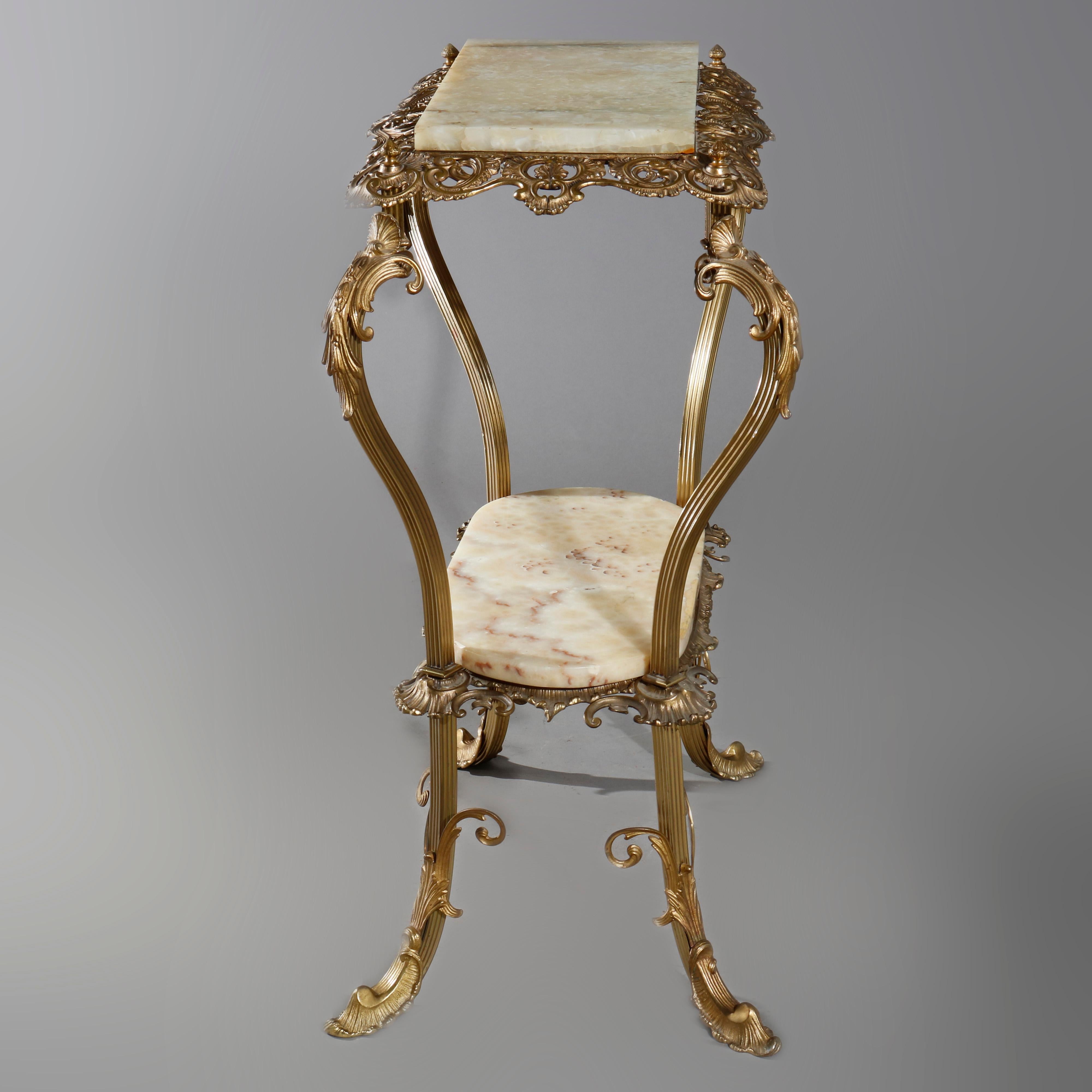 An antique French Louis XIV side stand offers onyx plate surmounting gilt bronze frame having pierced foliate, scroll and gadroon surround over lower onyx display, raised on cabriole legs having acanthus knees and feet, circa 1890

Measures: 32.5