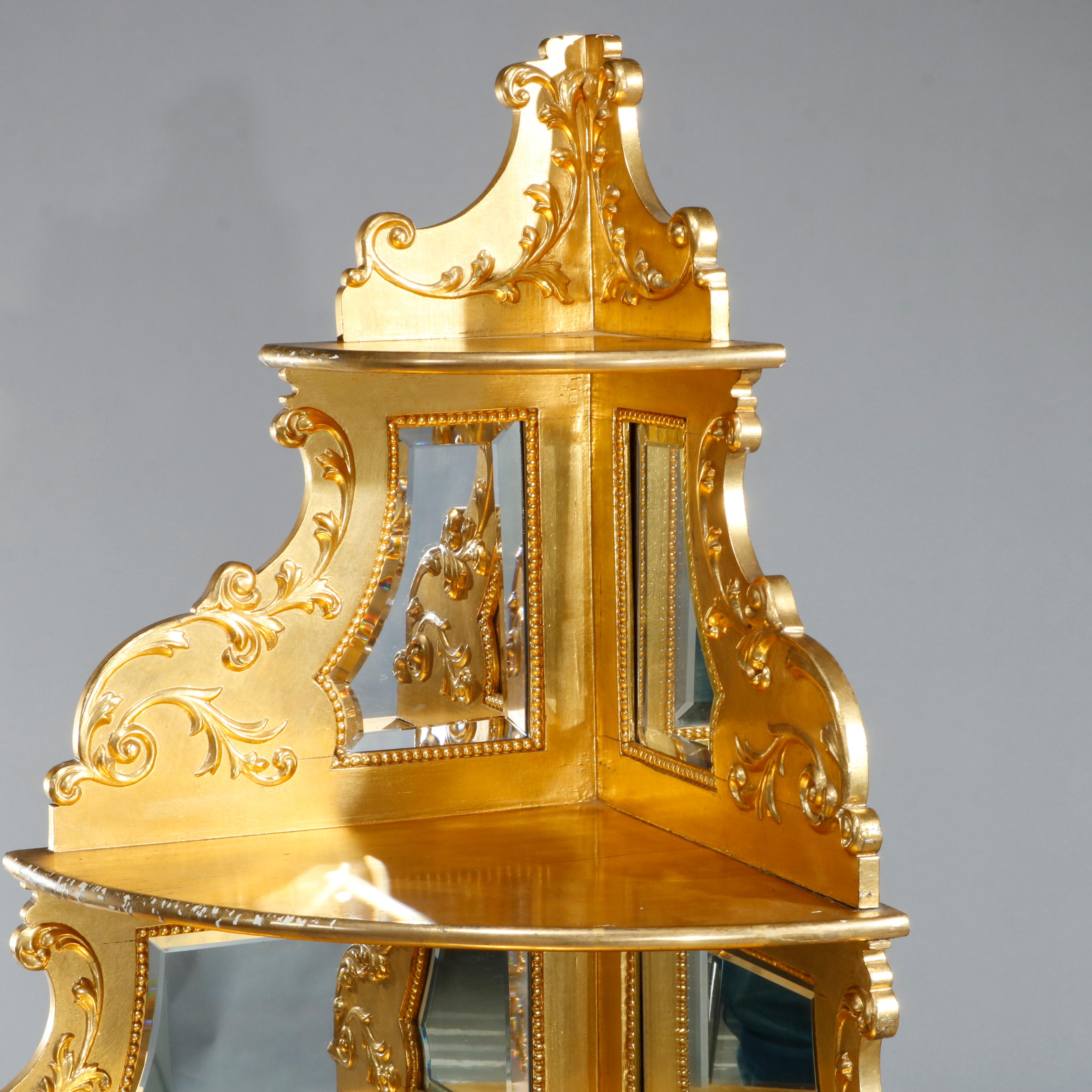 An antique French Louis XIV corner étagère offers giltwood (gold leaf covered) construction with graduated shelving flanked by mirror panels, scroll and acanthus foliate elements, raised on cabriole legs having shaped lower display and scroll form