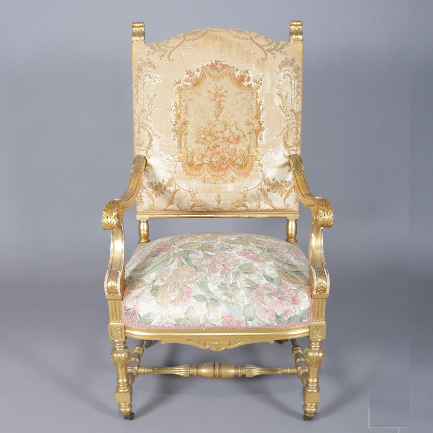 Antique French Louis XIV throne chair features carved giltwood frame having scroll and acanthus form arms, tapestry upholstery with urn and garden motif, seated on casters, 19th century

Measures: 47.5