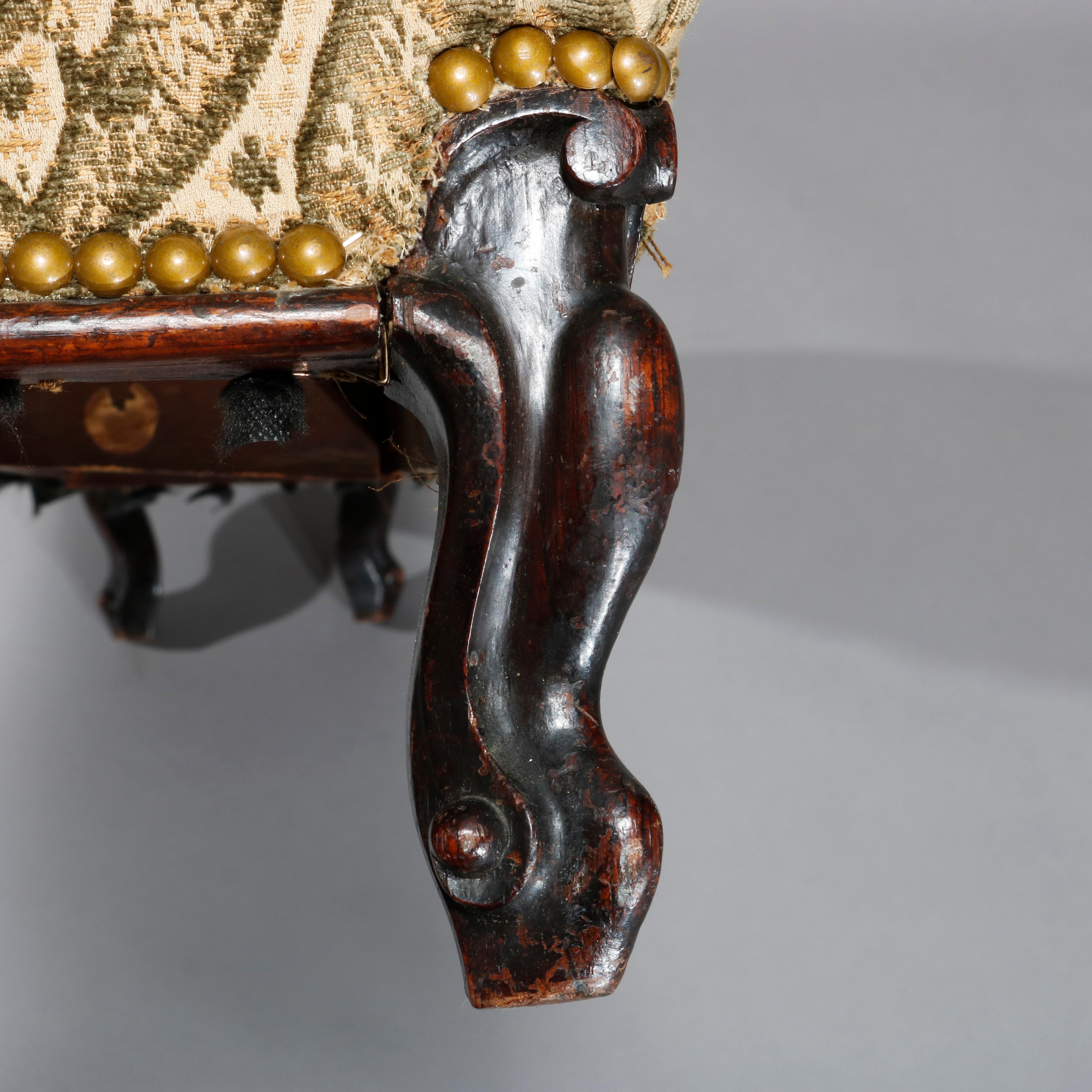 An antique French Louis XIV kneeling prayer bench offers upholstered cushion with brass tacks raised on carved mahogany cabriole legs terminating in scroll feet, c1890

Measures: 8.75