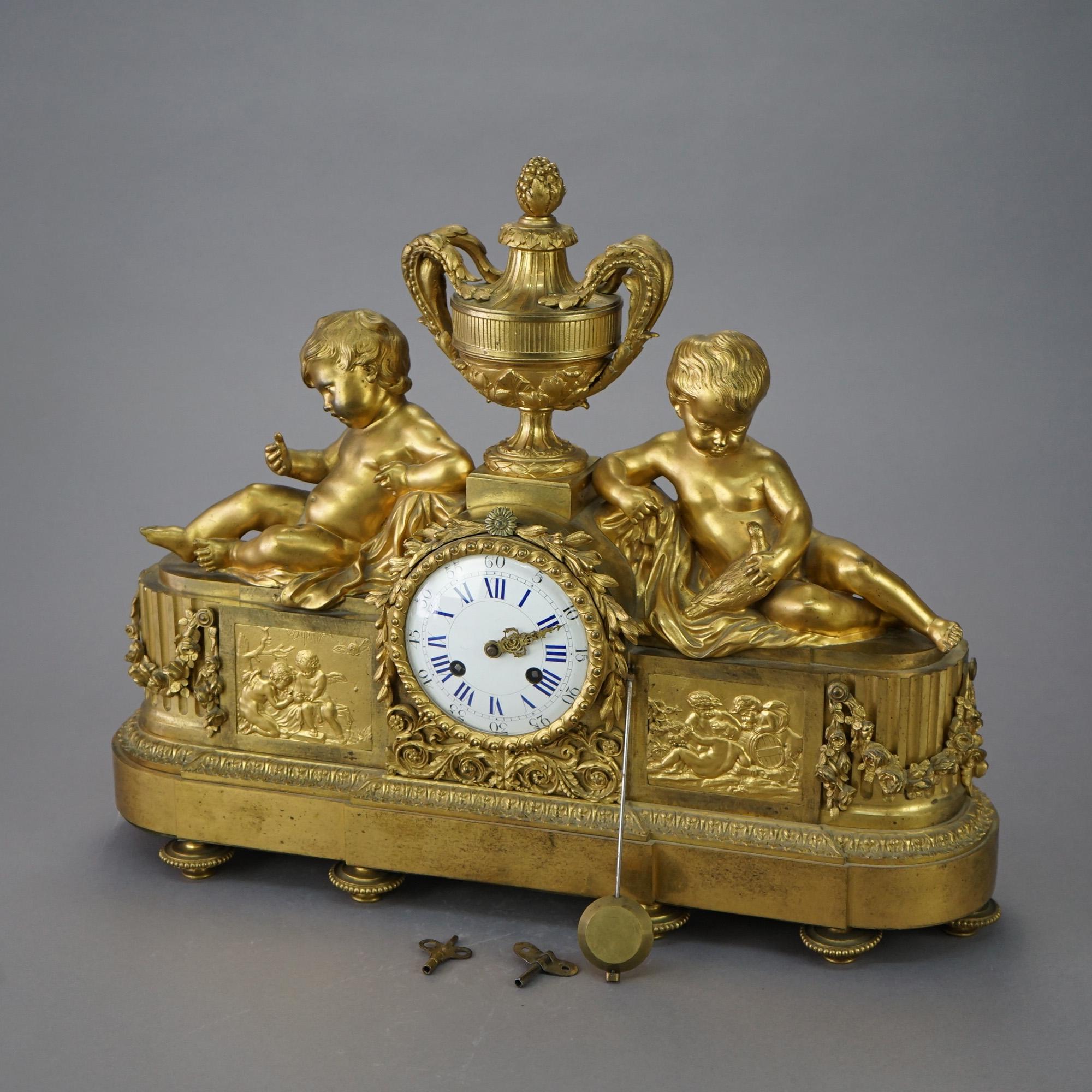 An antique French Louis XI Neoclassical mantel clock offers gilt cast bronze construction with central urn having flanking putti over oblong case with garland, embossed foliate and cherub scenes, raised on Marseilles bun feet, 19th