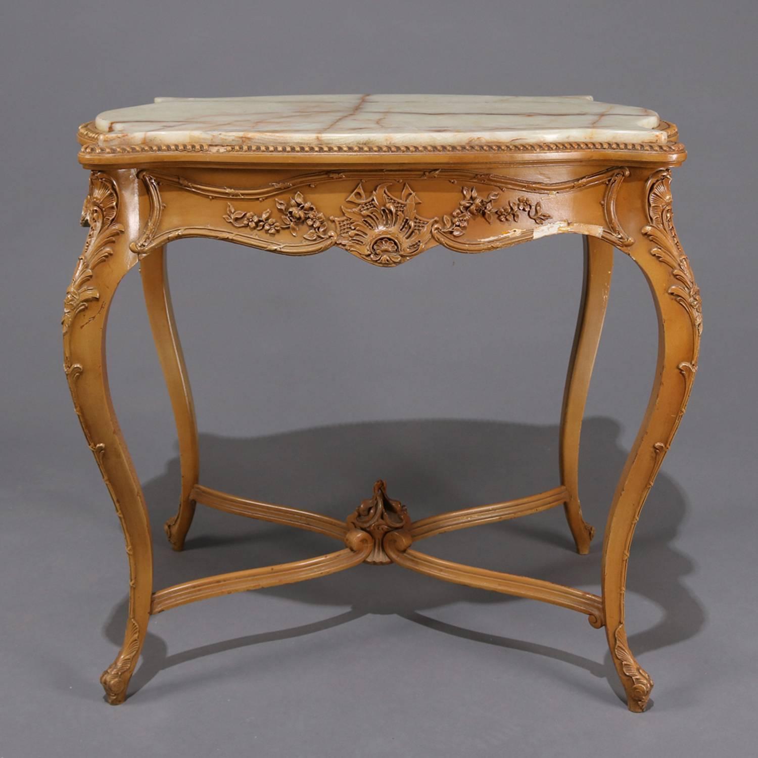 Antique French Louis XIV painted giltwood table features carved foliate and floral decoration with a shaped top having an onyx inset, seated on cabriole legs with X-stretcher with scroll and flame form central finial, circa 1890

Measures: 29.5