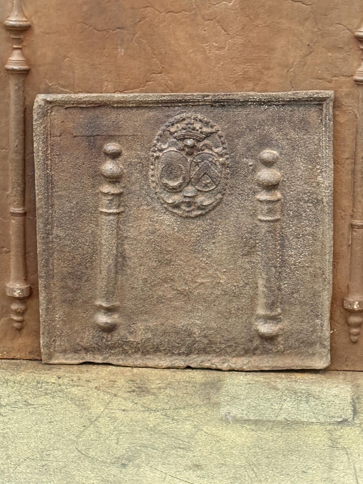 Parafuoco francese del periodo Luigi XIV con stemma. XVII secolo. I pilastri, le cosiddette colonne d'Ercole, rappresentano la clava di Ercole. Simboleggiano la forza e l'ignoto.

Lo schienale è in ghisa e presenta una patina marrone naturale. Su