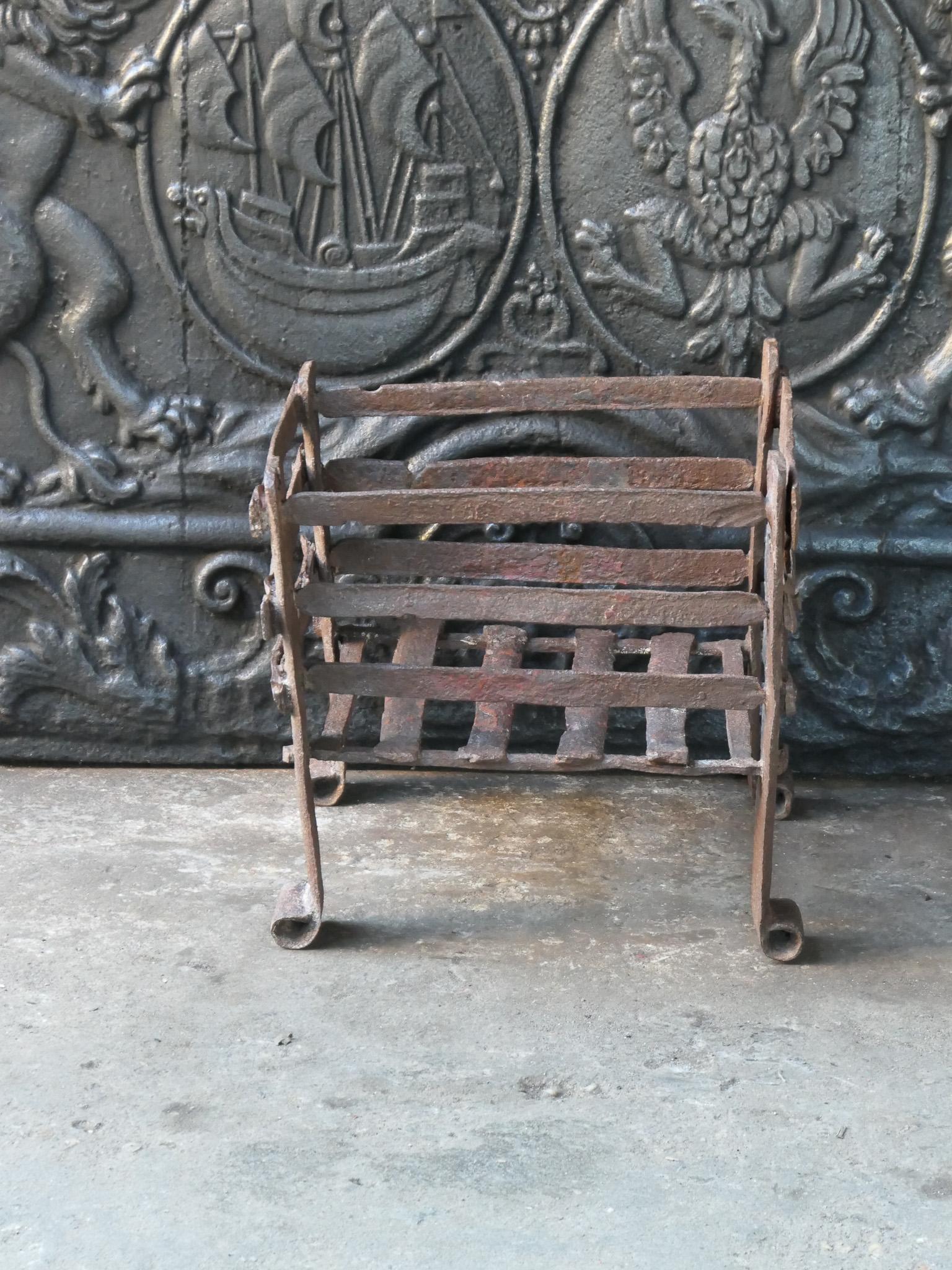 French 17th century fireplace basket or fire grate from the Louis XIV period. The fireplace grate is hand forged of wrought iron. The condition is good. 



















 