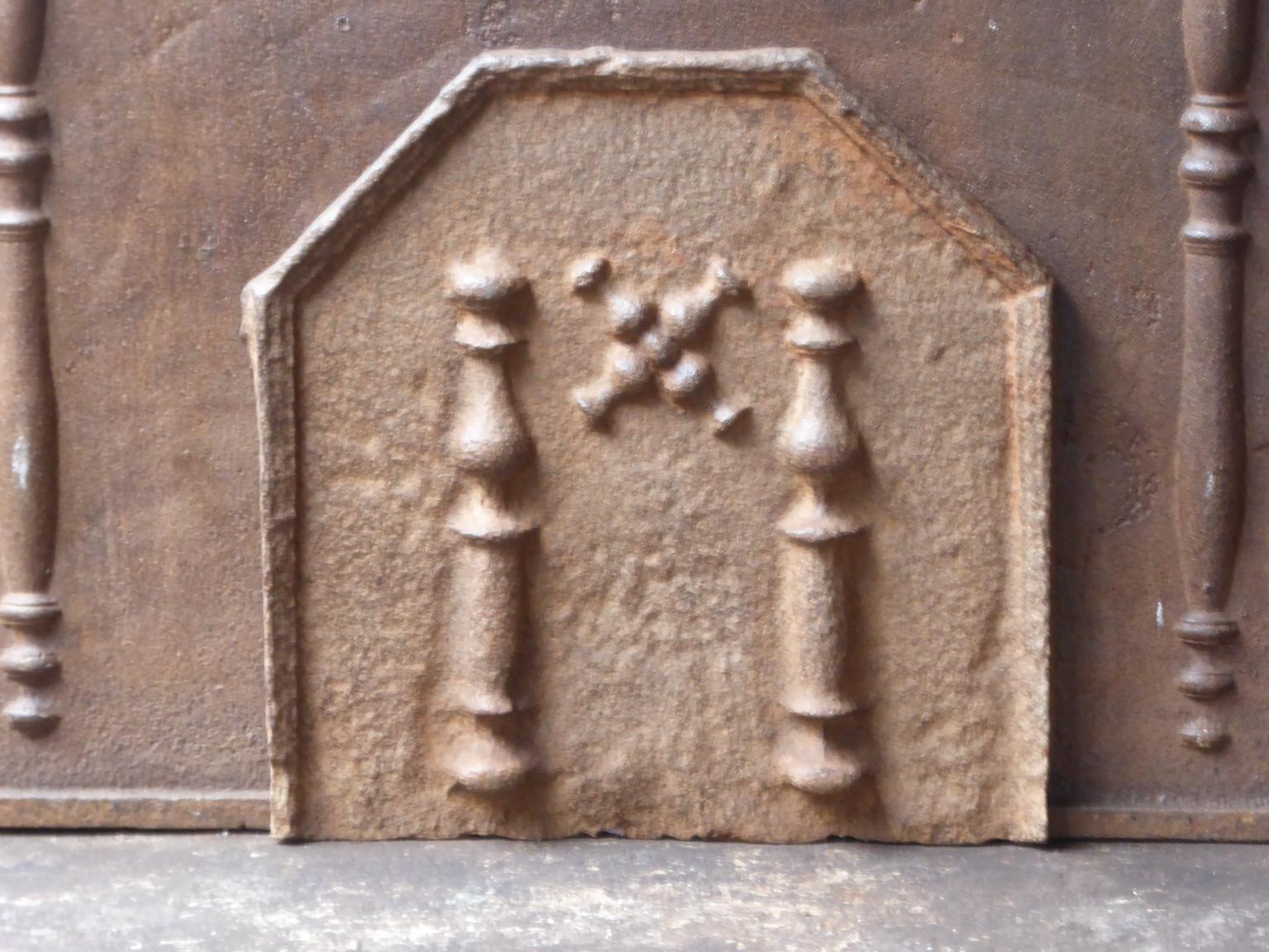 17th-18th century French fireback with a Saint Andrew's cross and two pillars of Hercules. Saint Andrew is said to have been martyred on a cross in this shape. The cross is since then a sign for humility and sacrifice. The pillars of Hercules