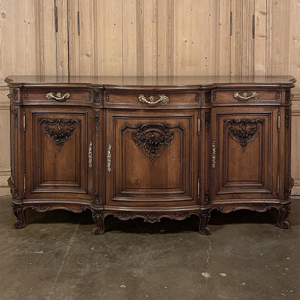 Antique French Louis XIV Serpentine walnut buffet is an extraordinary example of the breed, with complex contours and naturalistic form combined with artistic sculptural adornment to create a visual treasure! With no straight lines in the design,
